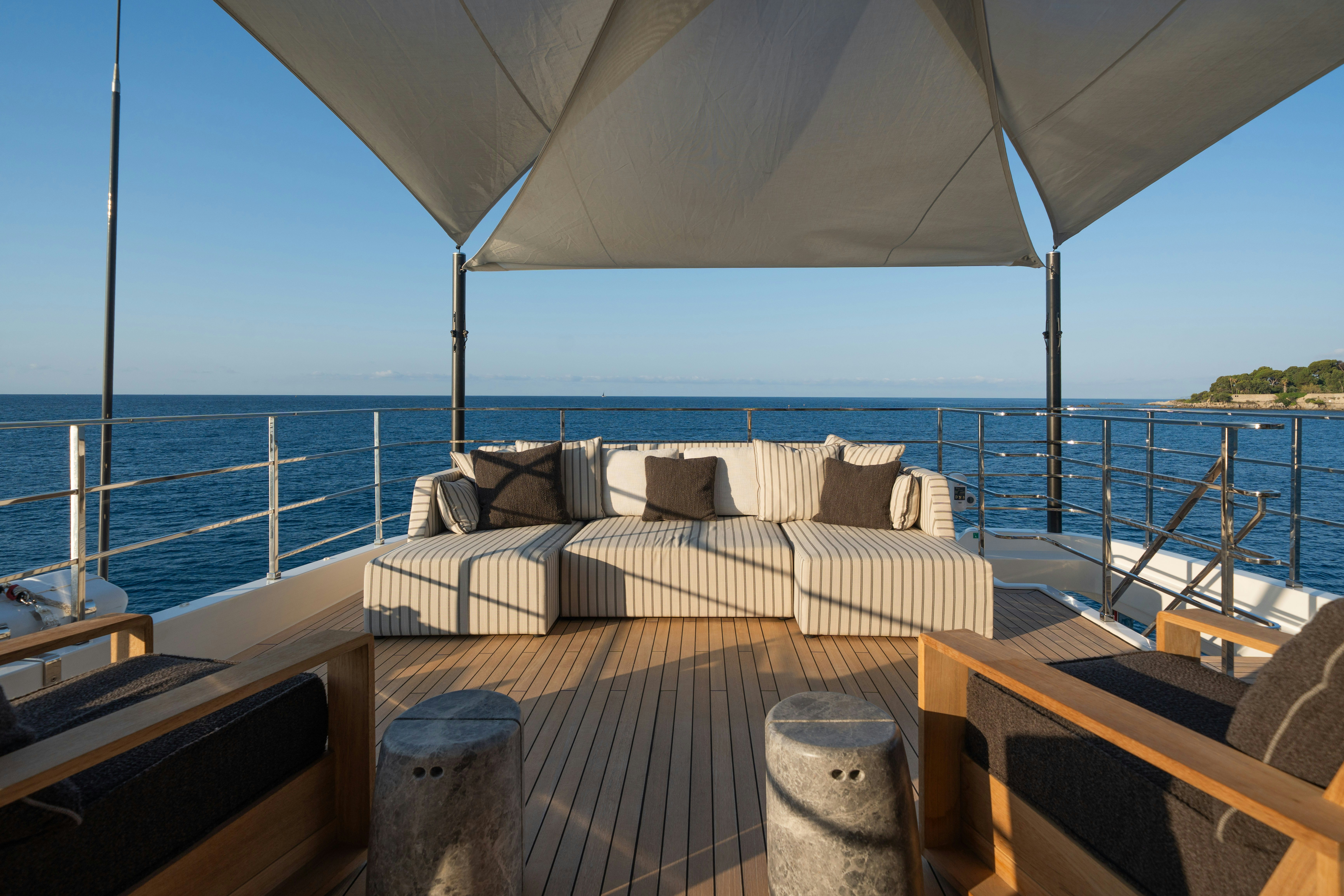 a deck with a view of the ocean and the ocean aboard PALOMA Yacht for Charter