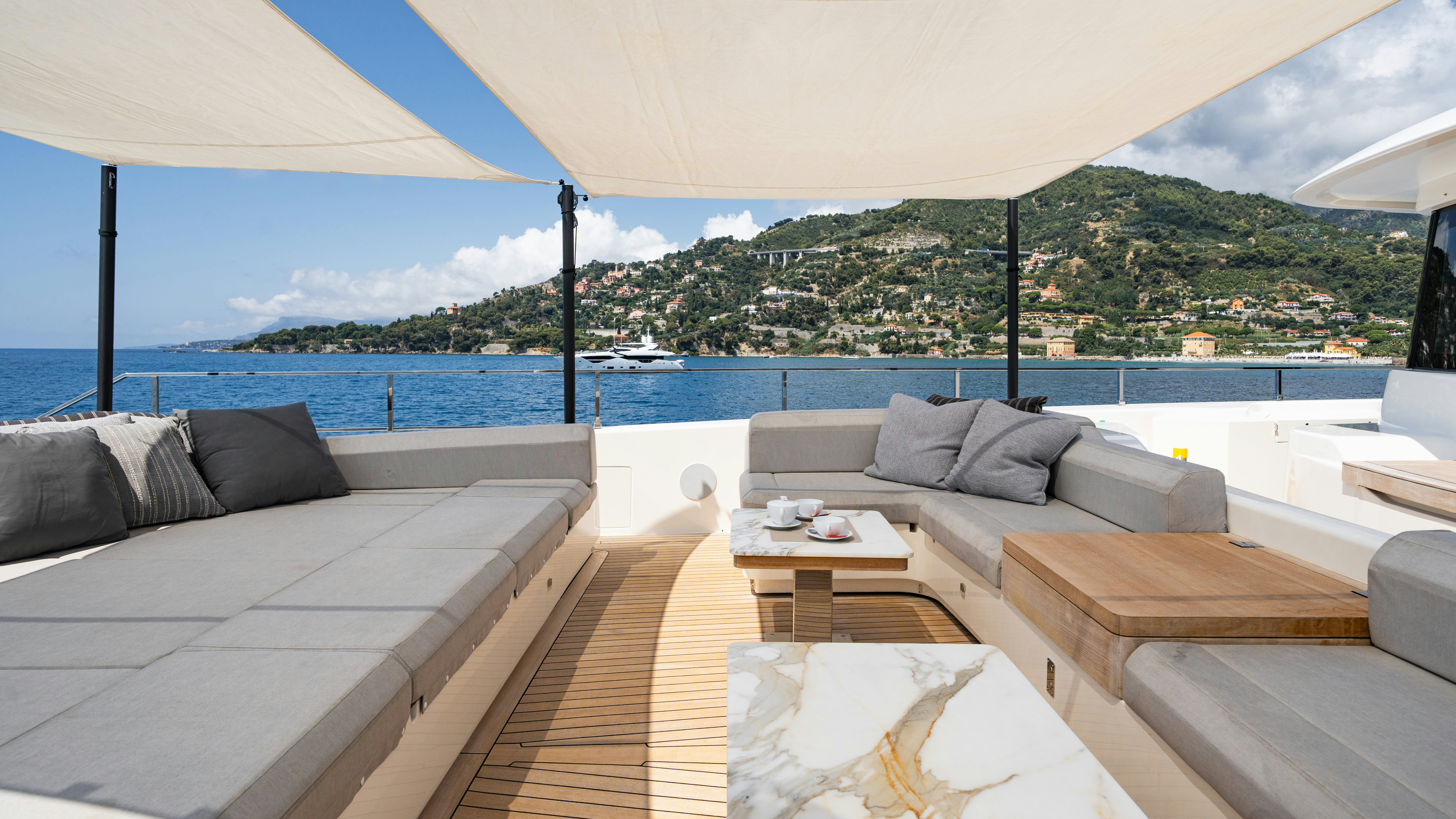 a room with a couch and a table and a large body of water aboard PALOMA Yacht for Charter