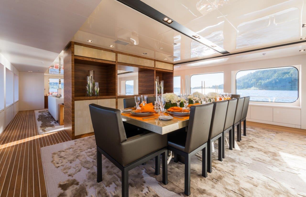 a dining room with a table and chairs aboard CHASSEUR Yacht for Charter