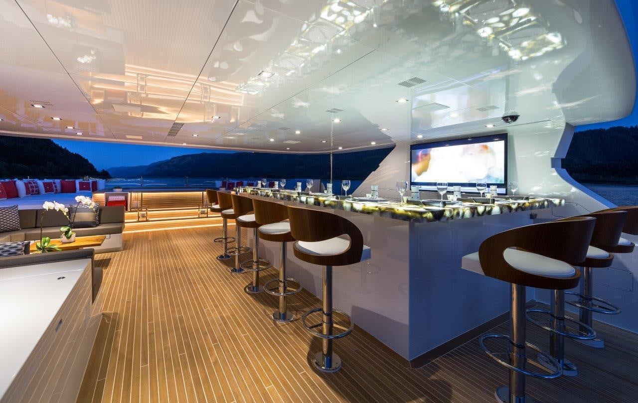 a room with a table and chairs aboard CHASSEUR Yacht for Charter