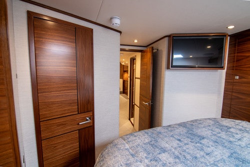 a bedroom with a bed and a television aboard CABALLO GRANDE Yacht for Sale