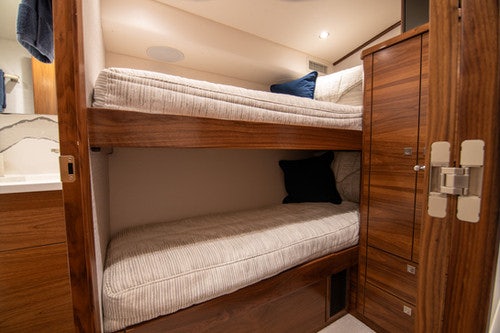 a bed with a wooden headboard aboard CABALLO GRANDE Yacht for Sale