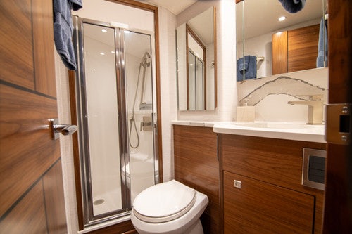 a bathroom with a glass shower door aboard CABALLO GRANDE Yacht for Sale
