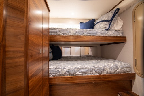 a bed with a wooden frame aboard CABALLO GRANDE Yacht for Sale