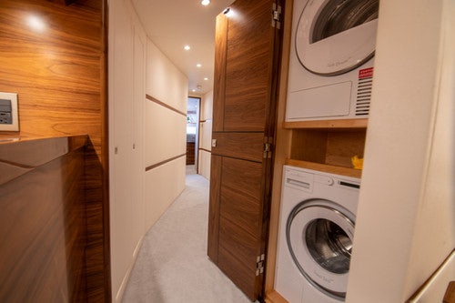 a laundry room with washer and dryer aboard CABALLO GRANDE Yacht for Sale