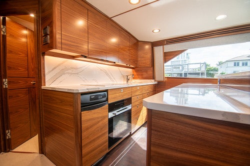 a kitchen with wooden cabinets aboard CABALLO GRANDE Yacht for Sale