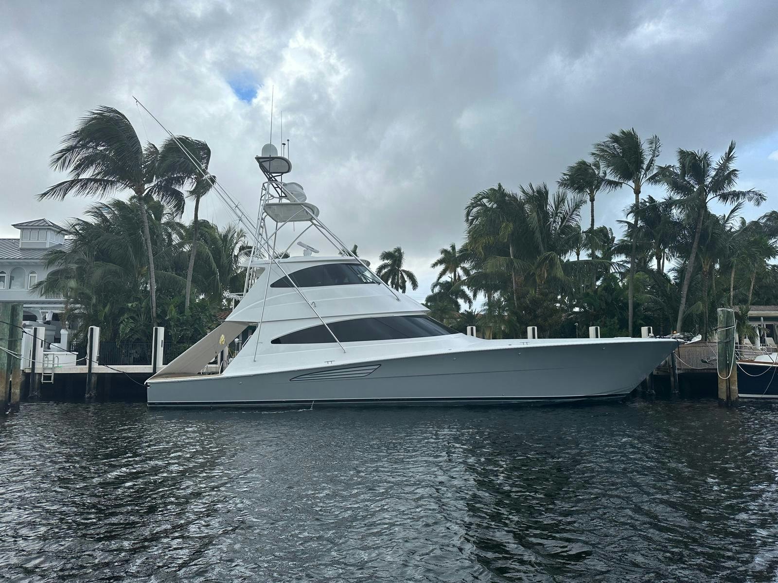 a white yacht in a harbor aboard CABALLO GRANDE Yacht for Sale