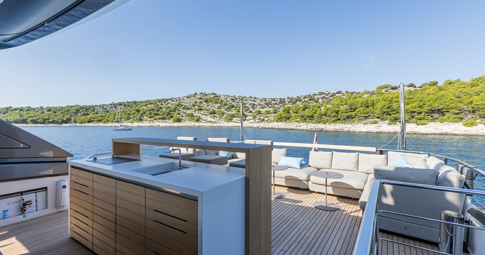 a deck with a view of a lake and trees aboard JICJ Yacht for Sale
