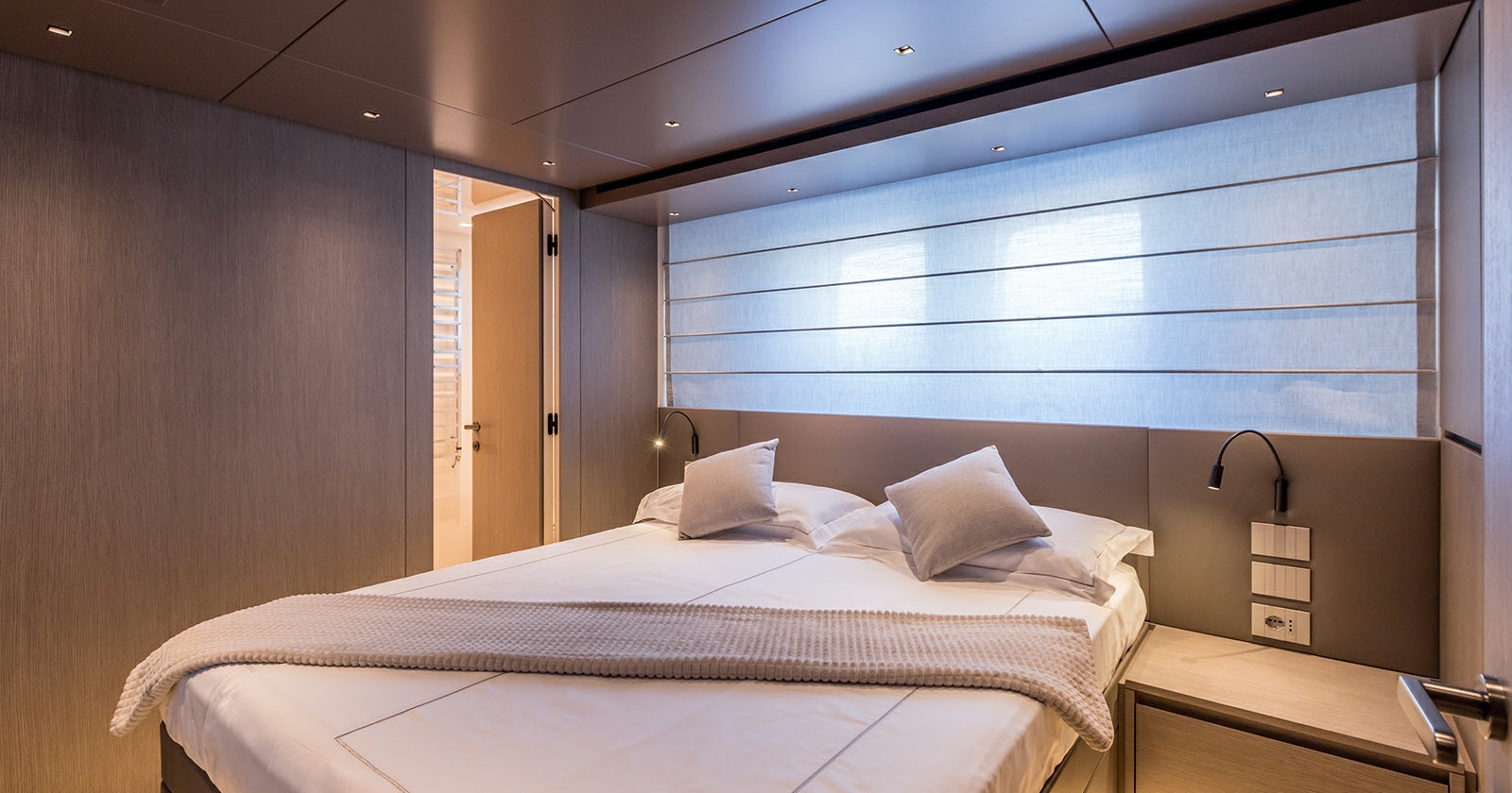 a bed with white sheets aboard JICJ Yacht for Sale