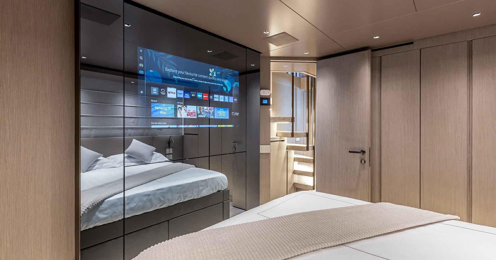 a room with a bed and a tv on the wall aboard JICJ Yacht for Sale