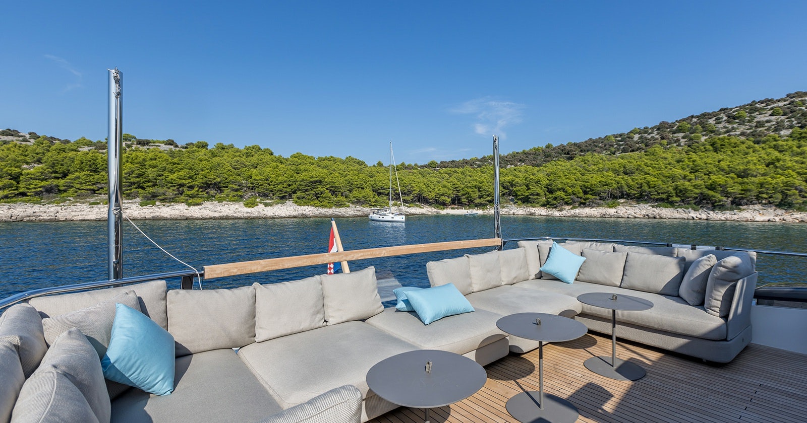 a large lounge chair on a deck overlooking a body of water aboard JICJ Yacht for Sale