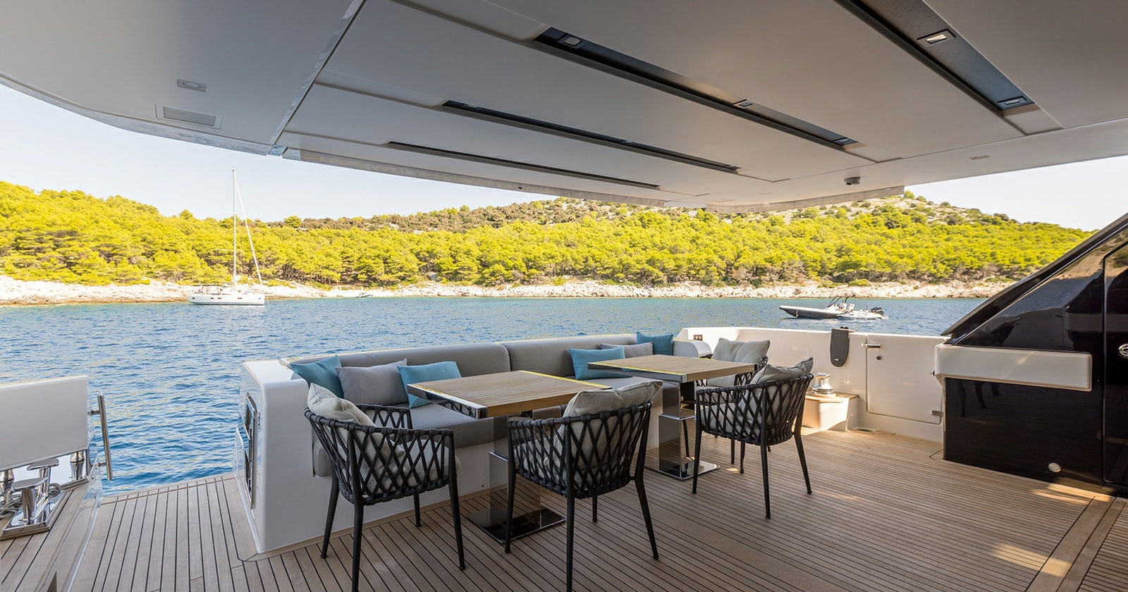 a patio with a table and chairs aboard JICJ Yacht for Sale