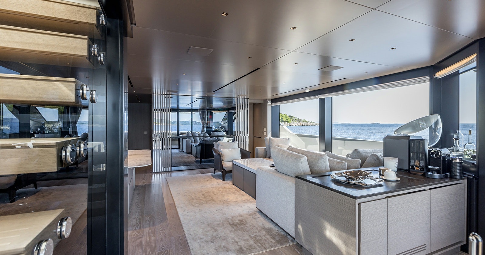 a large living room with a large window aboard JICJ Yacht for Sale