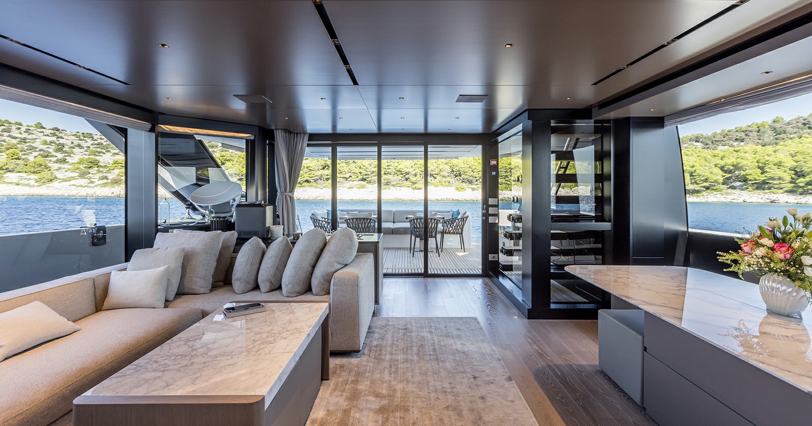 a living room with a large window aboard JICJ Yacht for Sale