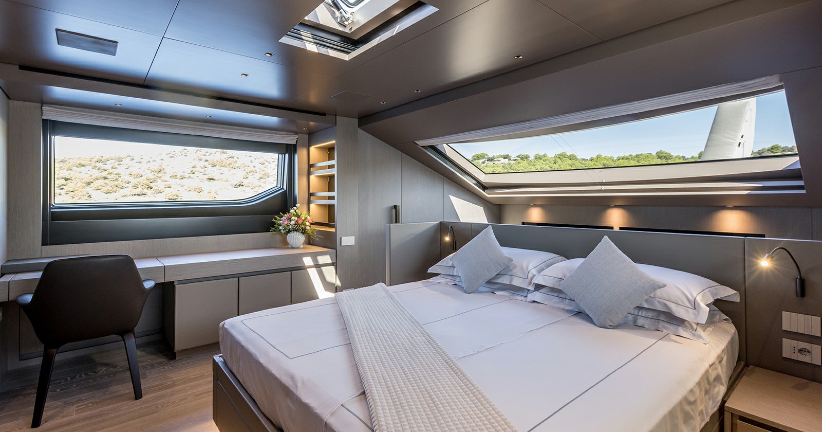 a room with a bed and a window aboard JICJ Yacht for Sale