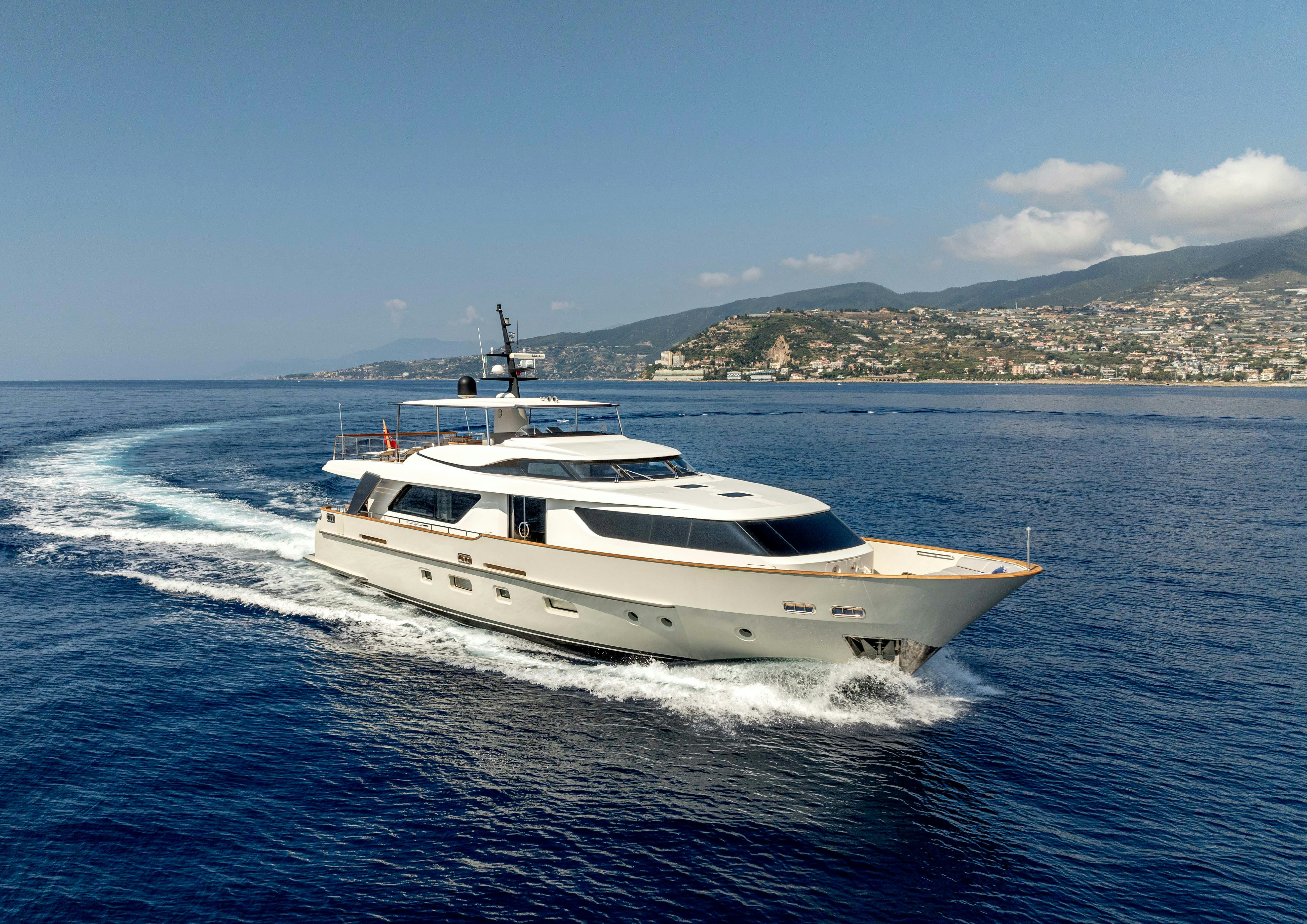 a white yacht on the water aboard SERENITY IV Yacht for Sale