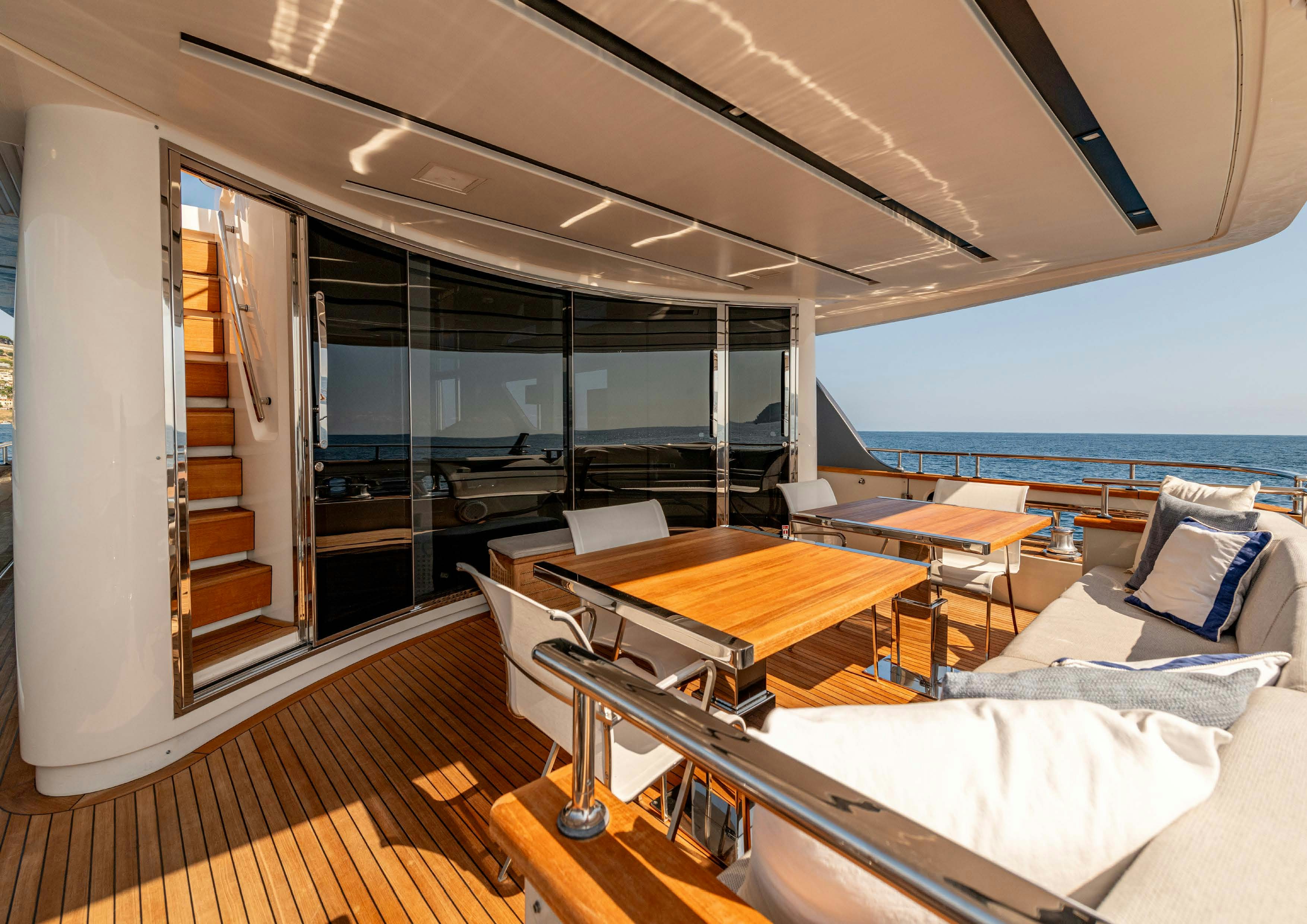 a room with a view of the ocean and the deck aboard SERENITY IV Yacht for Sale