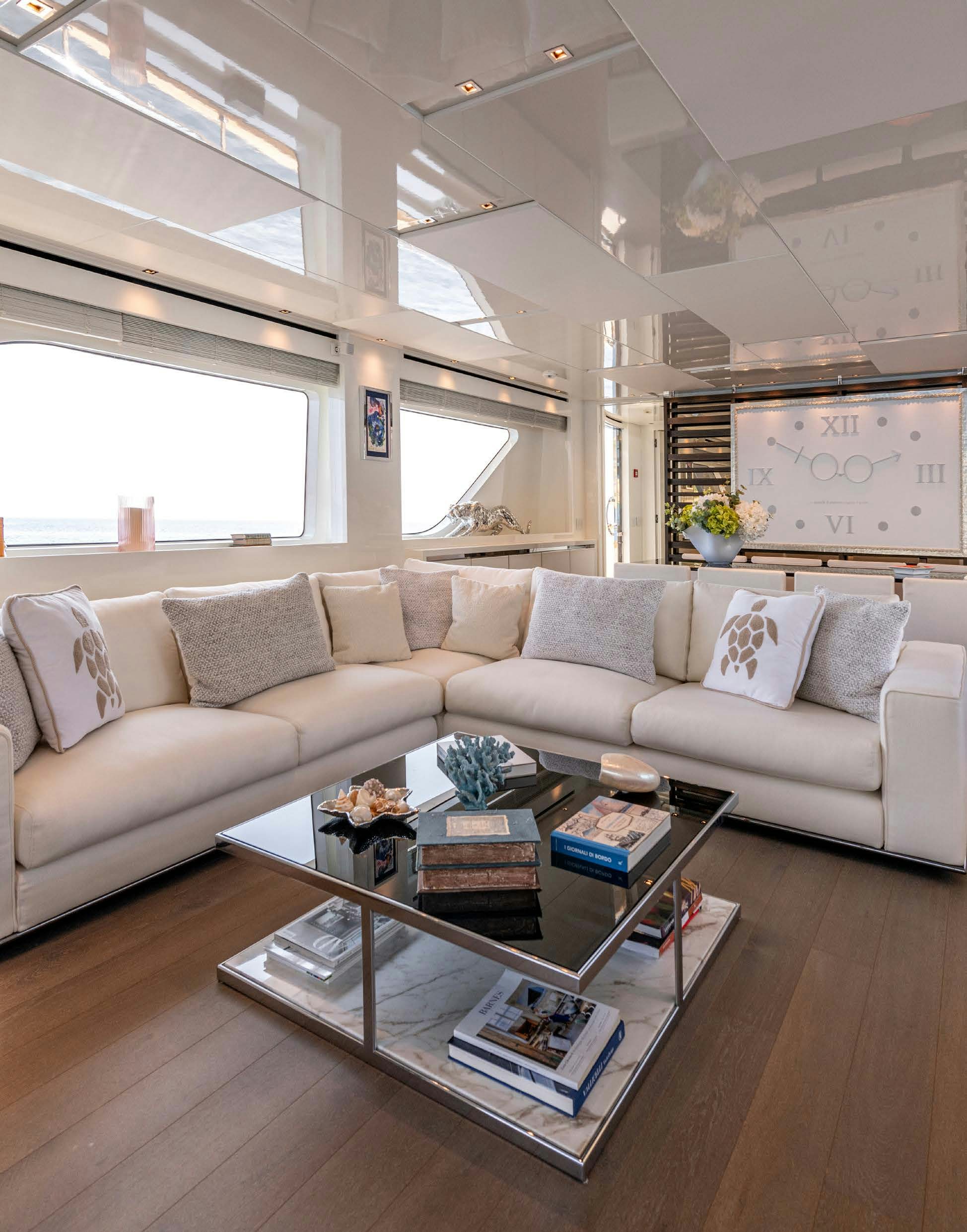 a living room with a white couch aboard SERENITY IV Yacht for Sale