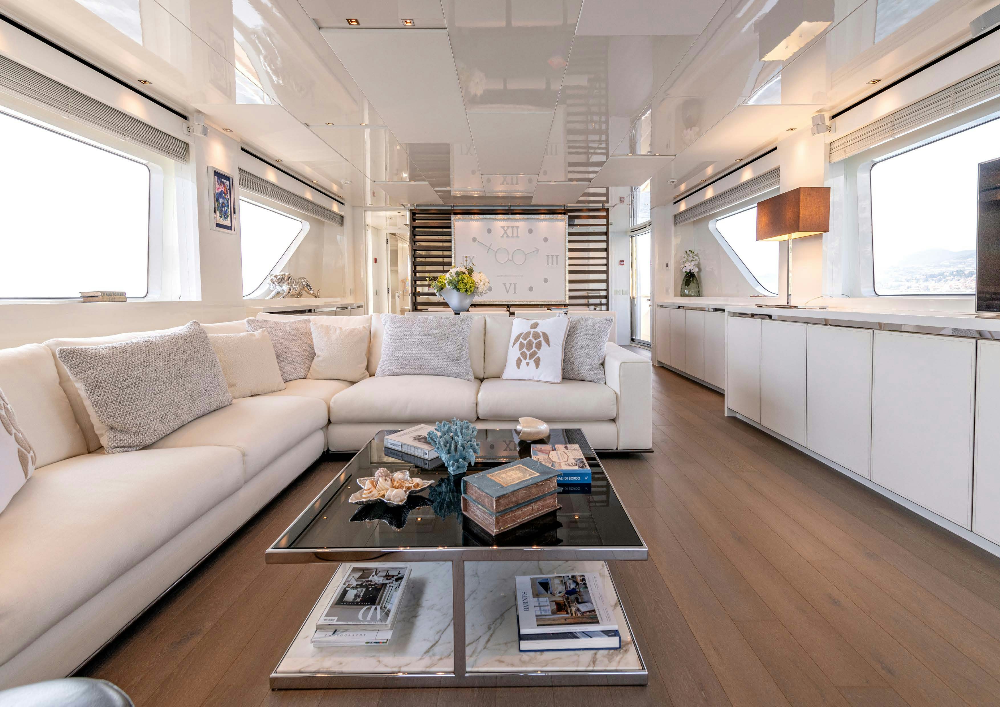 a living room with a couch and coffee table aboard SERENITY IV Yacht for Sale