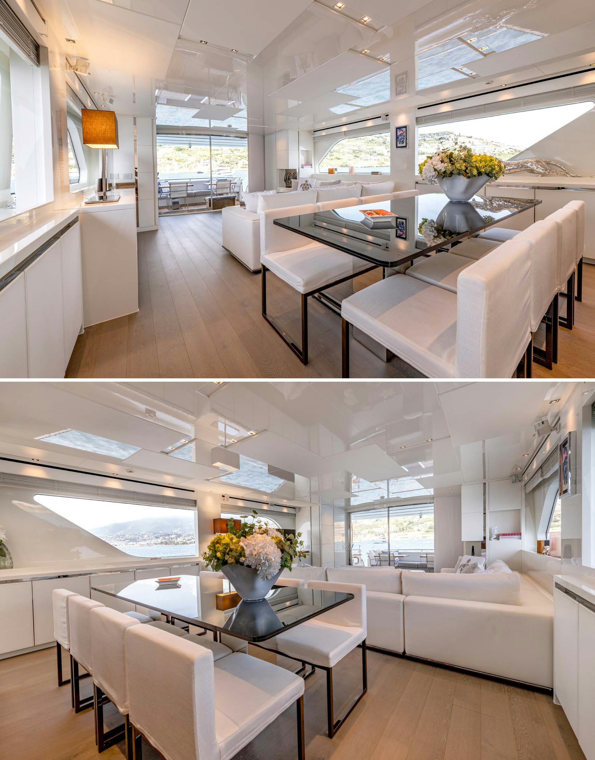 a room with a table and chairs aboard SERENITY IV Yacht for Sale