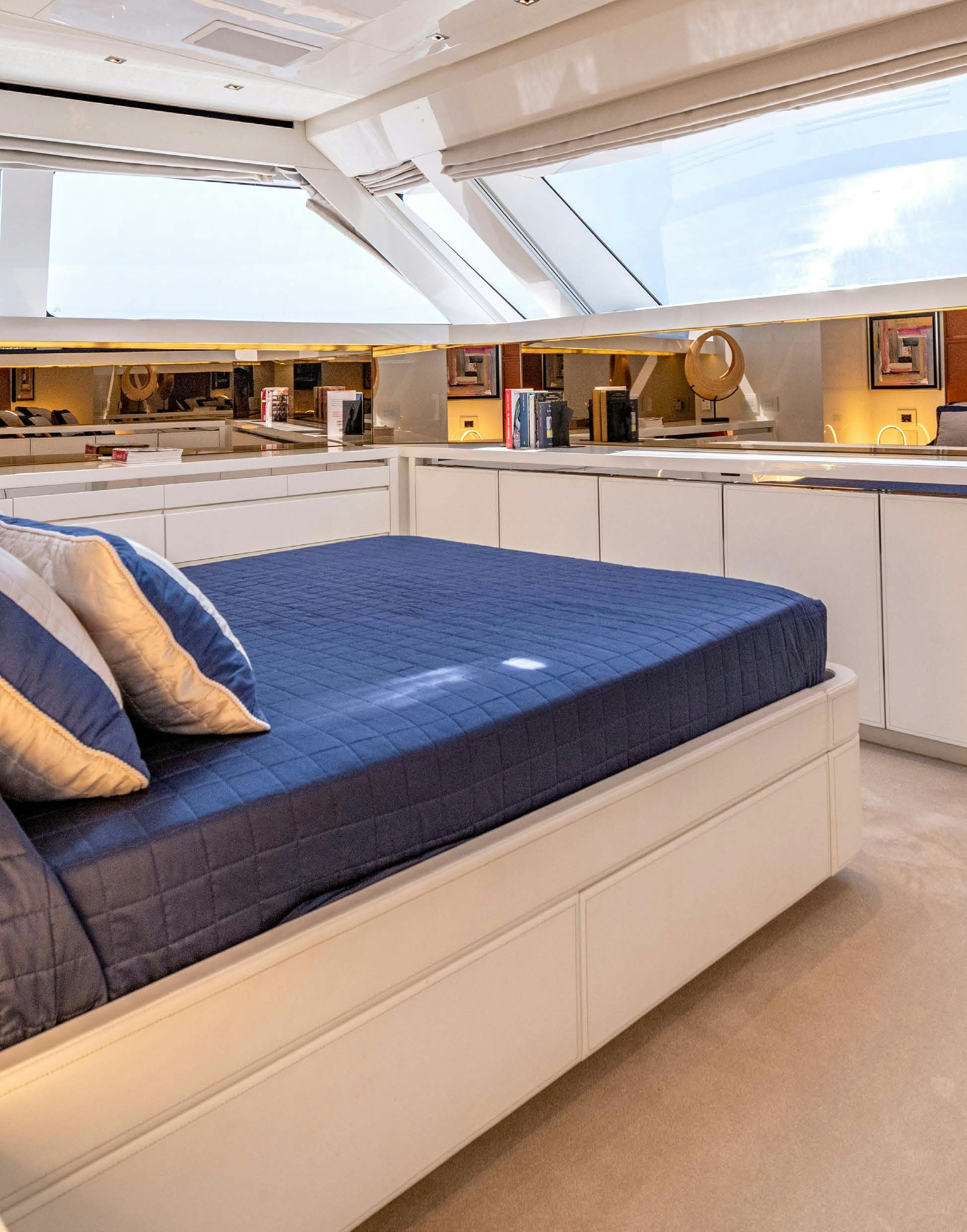 a room with a bed and a desk aboard SERENITY IV Yacht for Sale