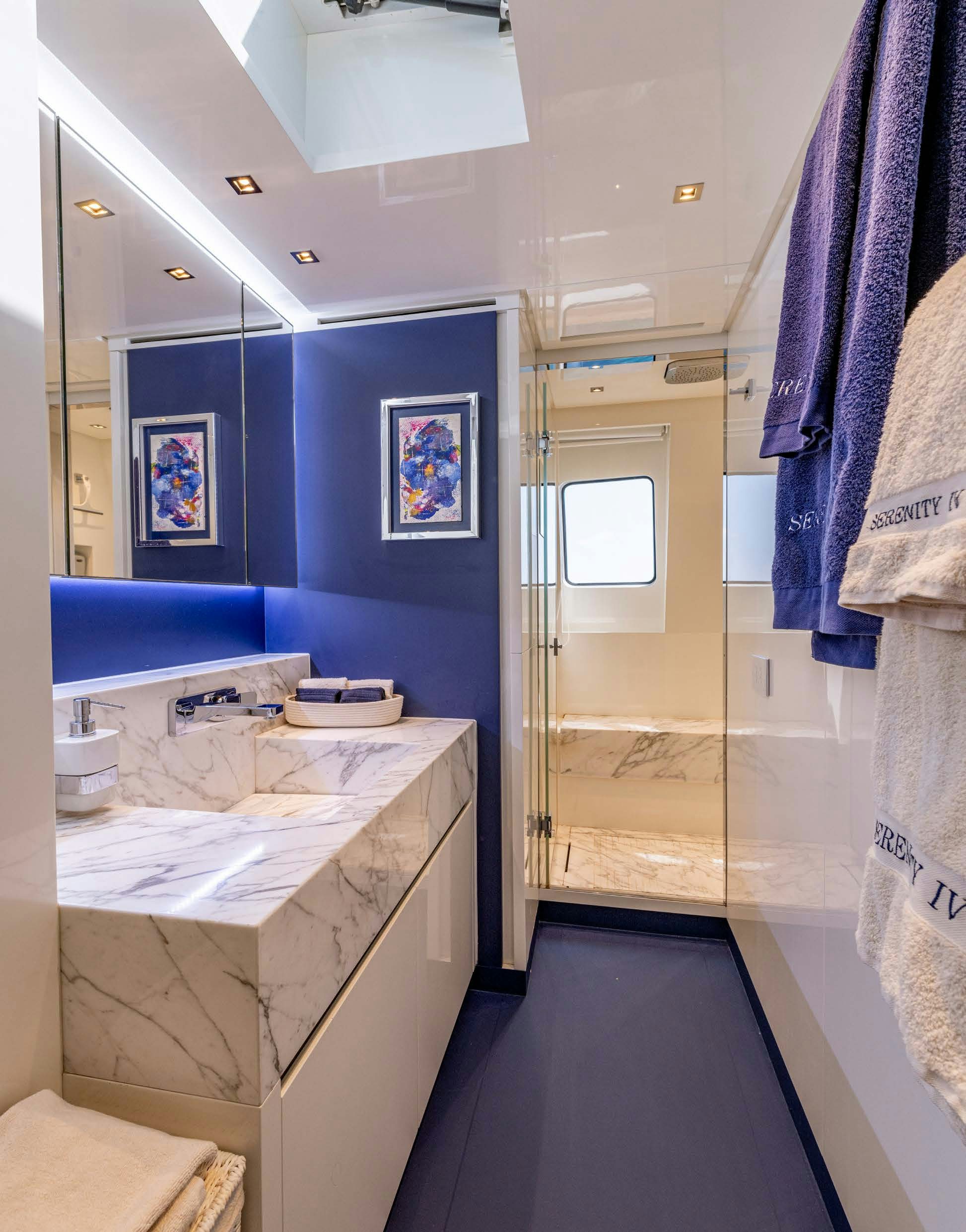 a bathroom with a countertop sink and mirror aboard SERENITY IV Yacht for Sale