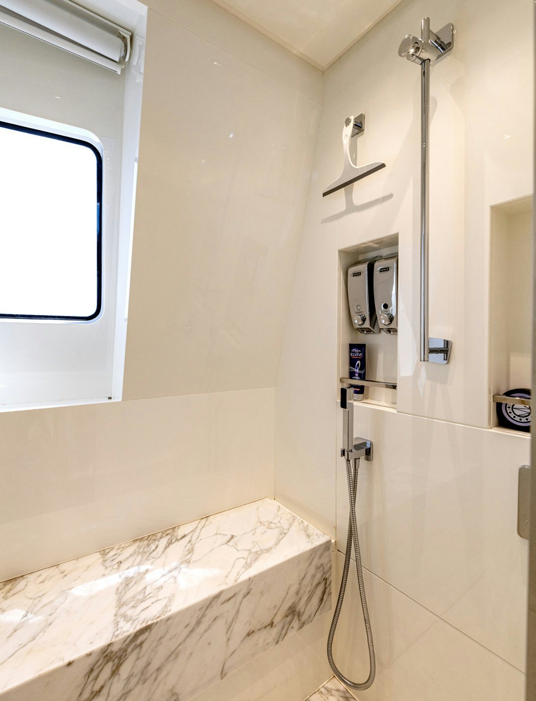 a bathroom with a shower and a sink aboard SERENITY IV Yacht for Sale