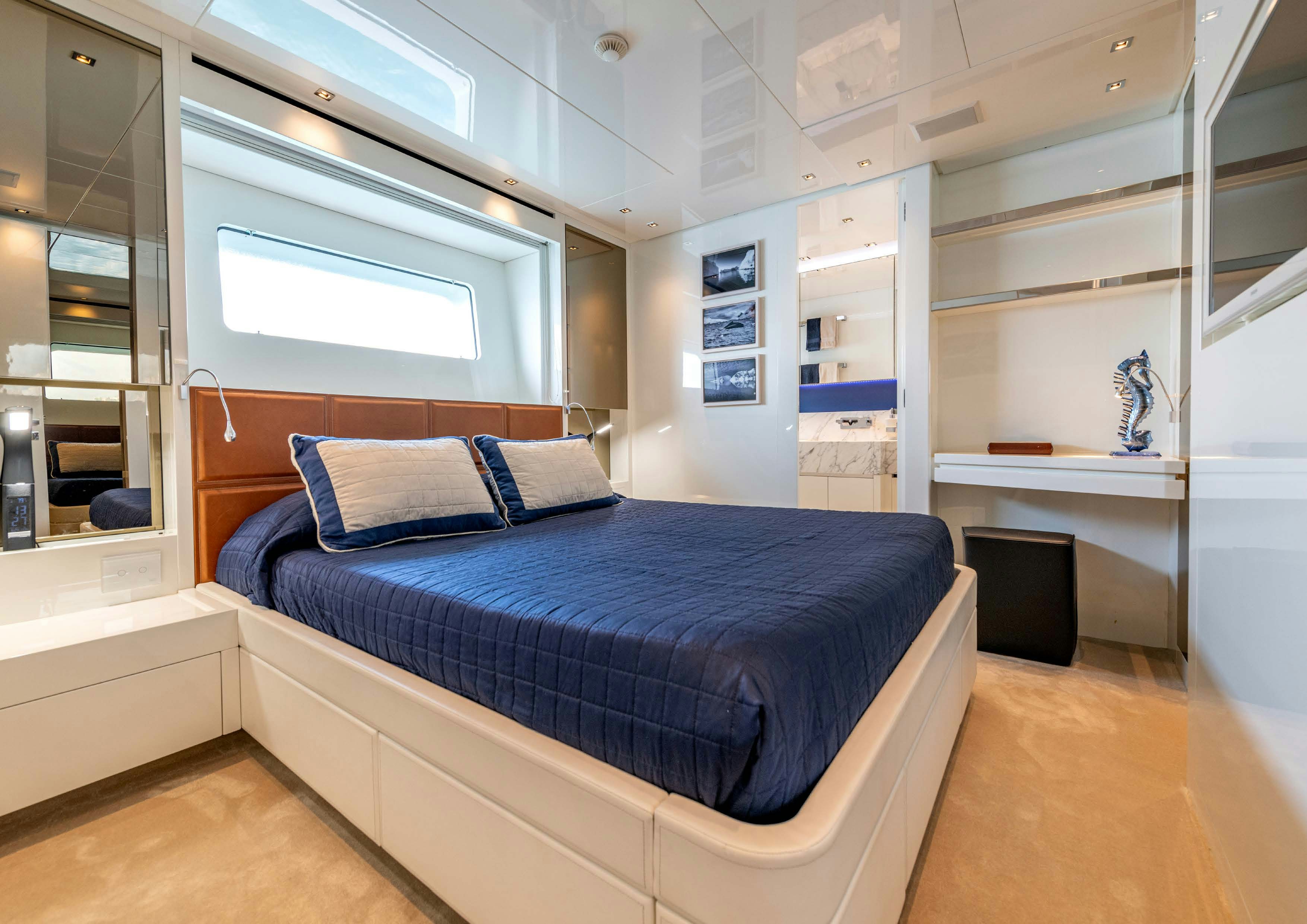 a room with a bed and a desk aboard SERENITY IV Yacht for Sale