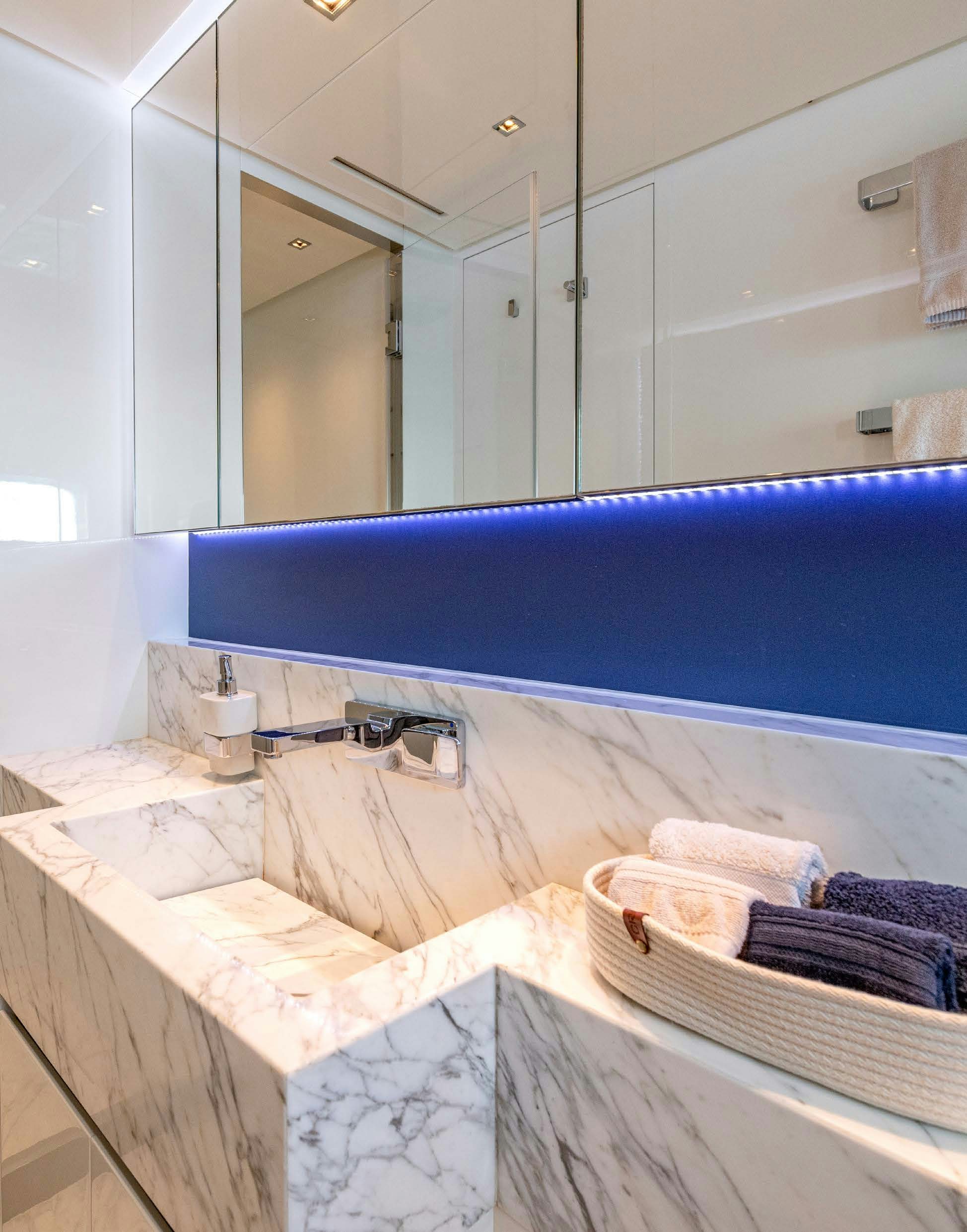 a bathroom with a large mirror aboard SERENITY IV Yacht for Sale