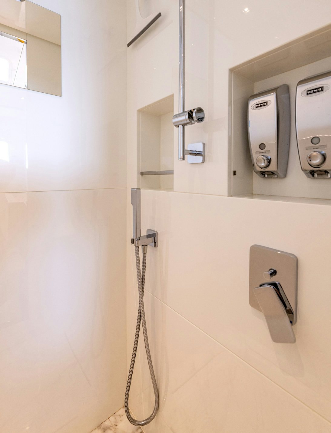 a bathroom with a few stalls aboard SERENITY IV Yacht for Sale