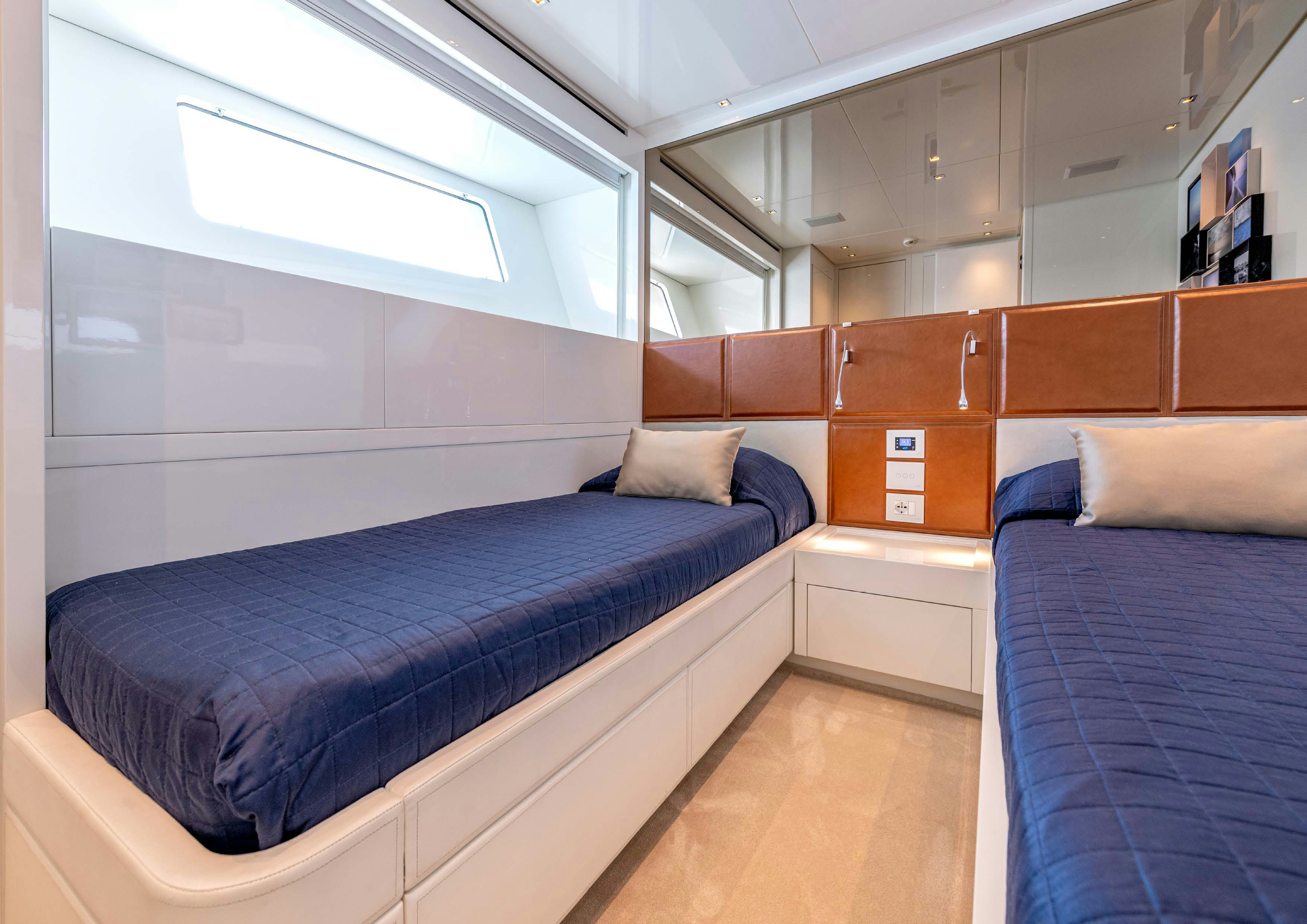 a room with a bed and a window aboard SERENITY IV Yacht for Sale
