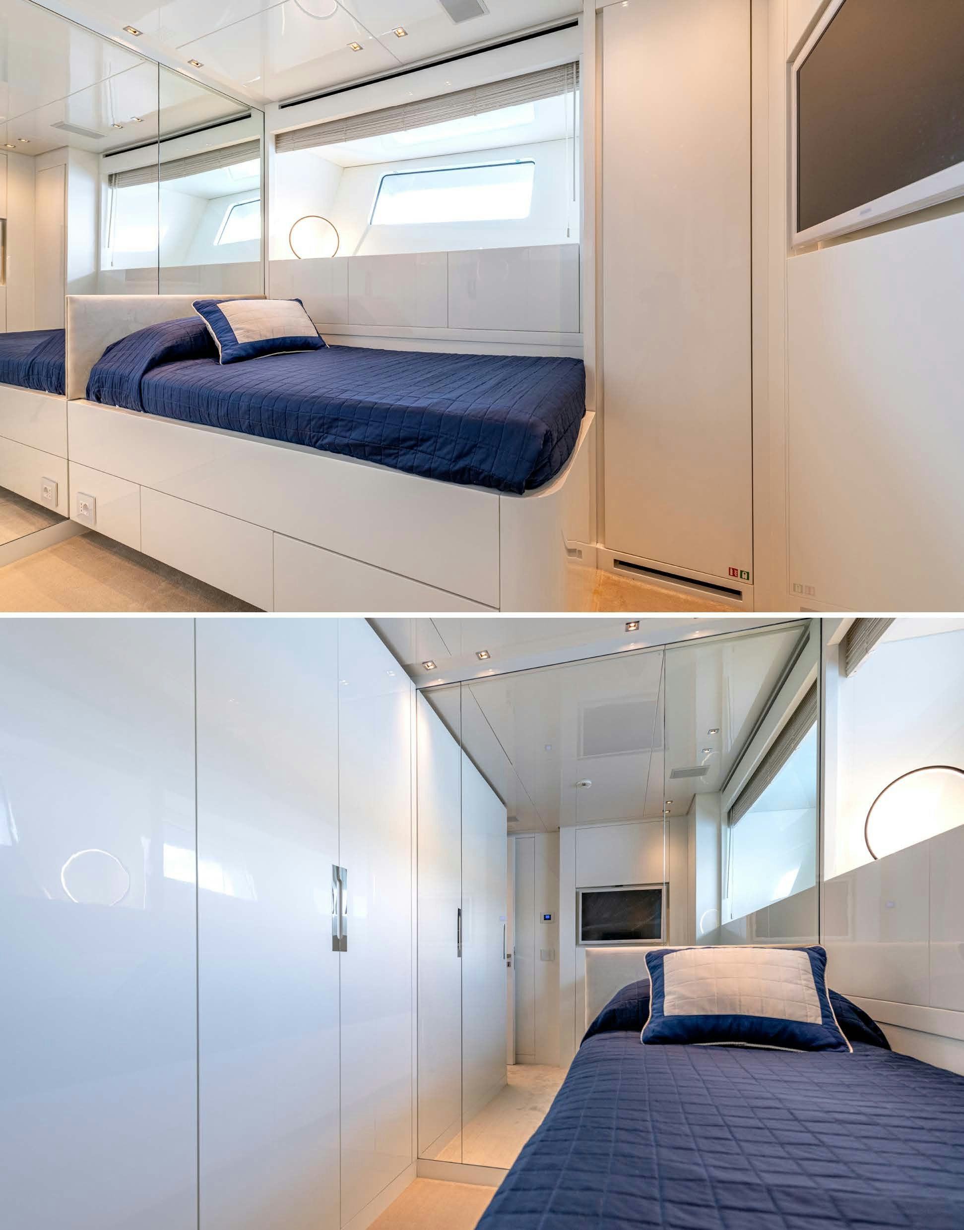 a room with a bed and a blue bed aboard SERENITY IV Yacht for Sale