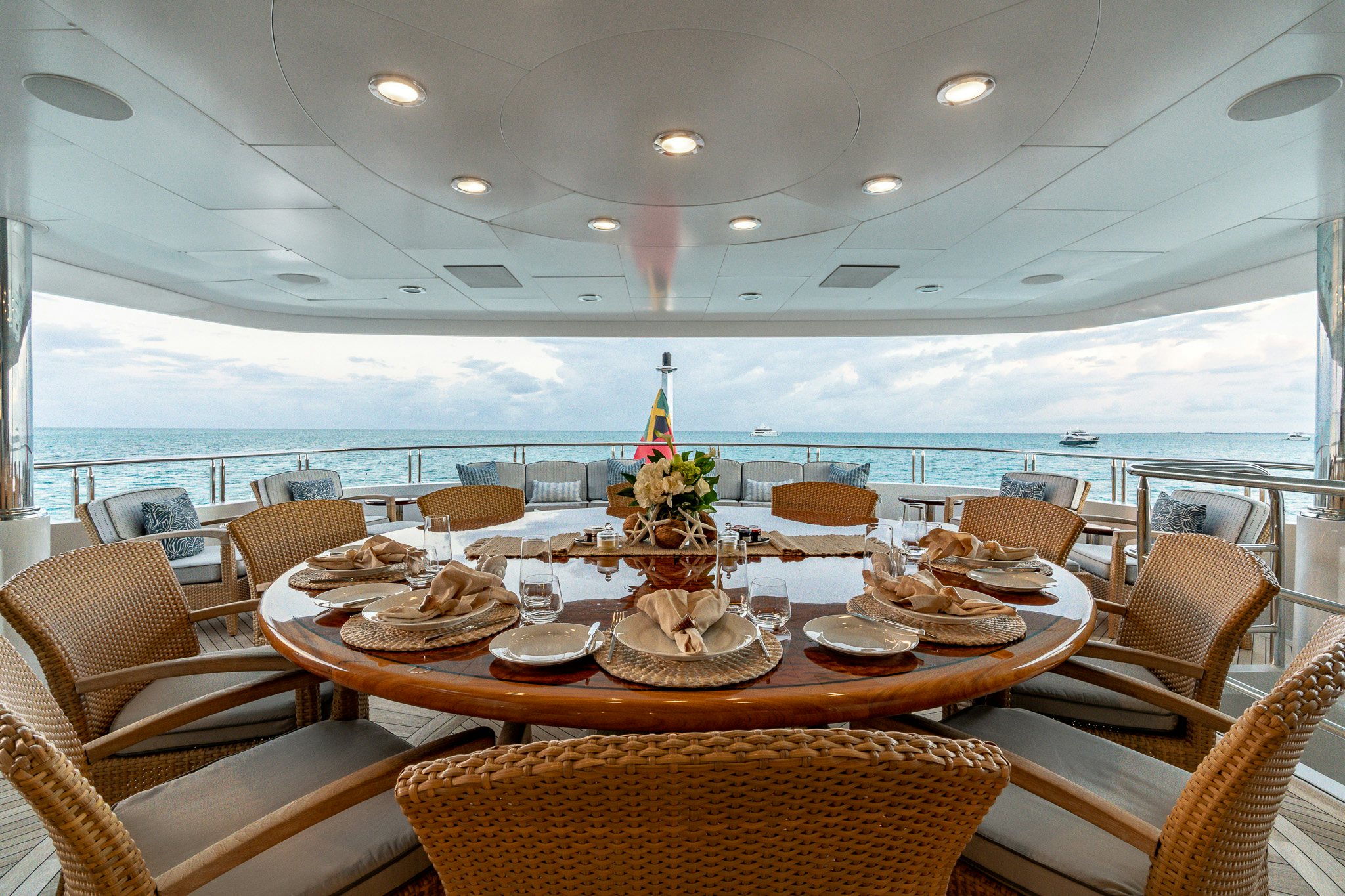 a table with plates and chairs around it aboard ZOOM ZOOM ZOOM Yacht for Charter