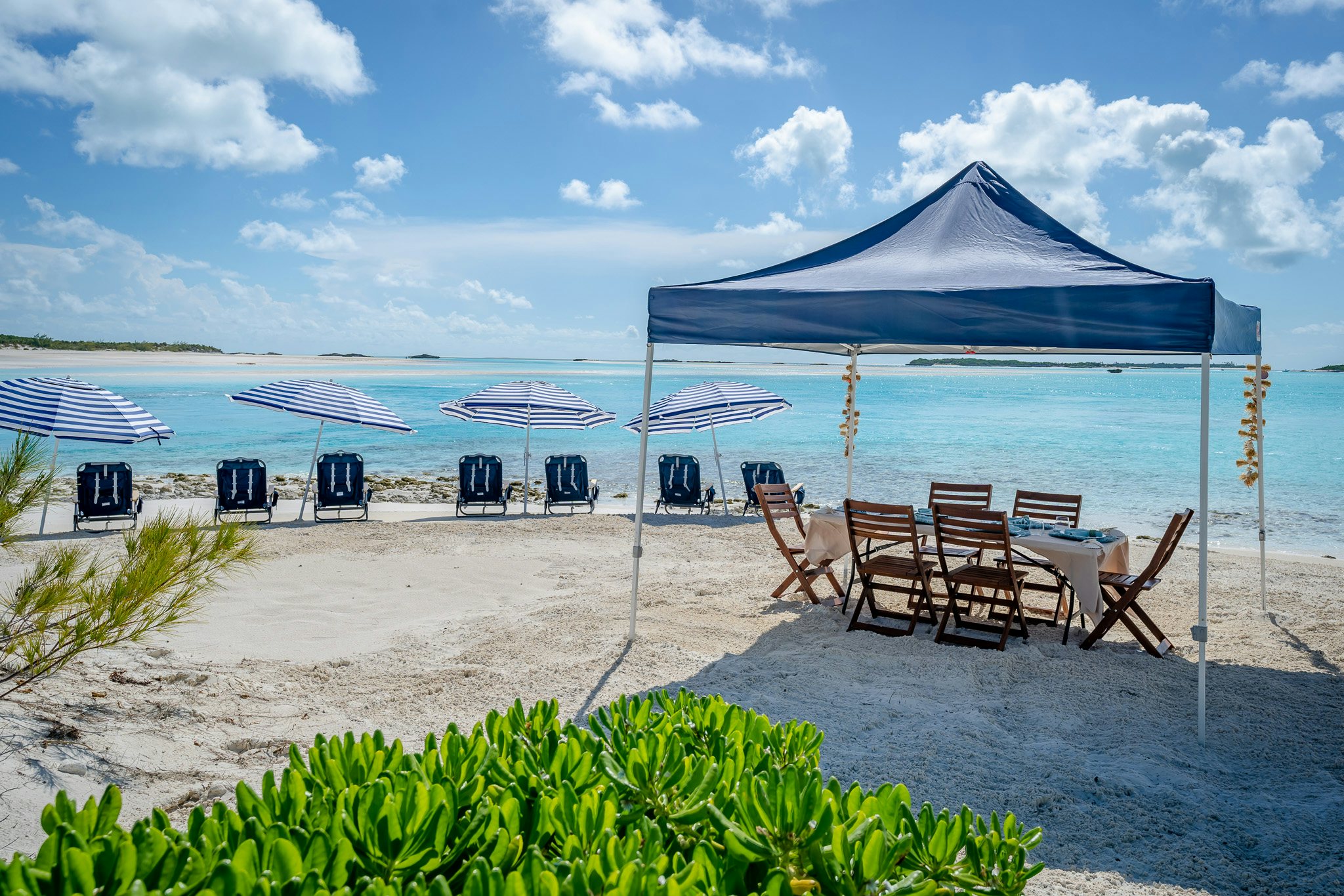 a beach with chairs and umbrellas aboard ZOOM ZOOM ZOOM Yacht for Charter
