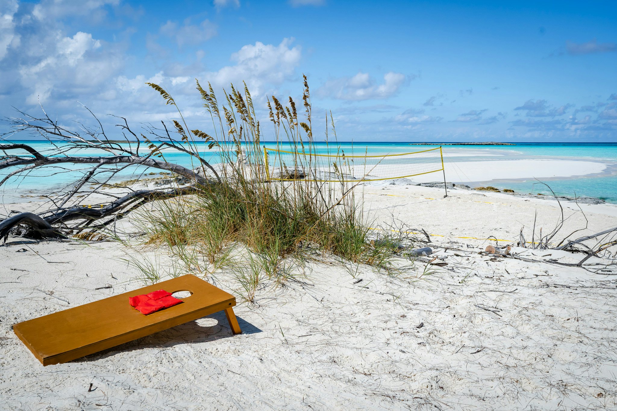 a yellow surfboard on a beach aboard ZOOM ZOOM ZOOM Yacht for Charter