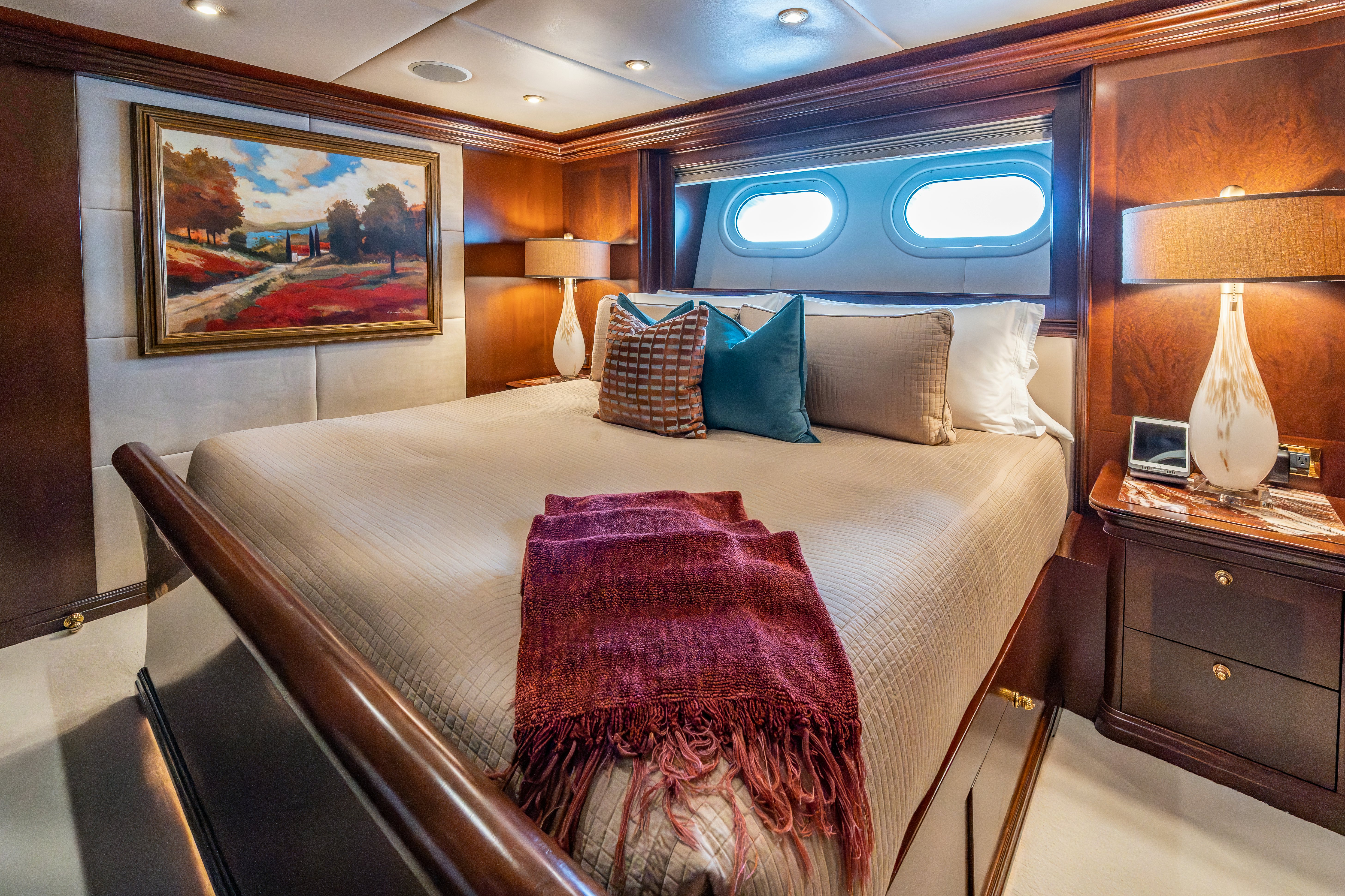a bed with purple sheets aboard ZOOM ZOOM ZOOM Yacht for Charter