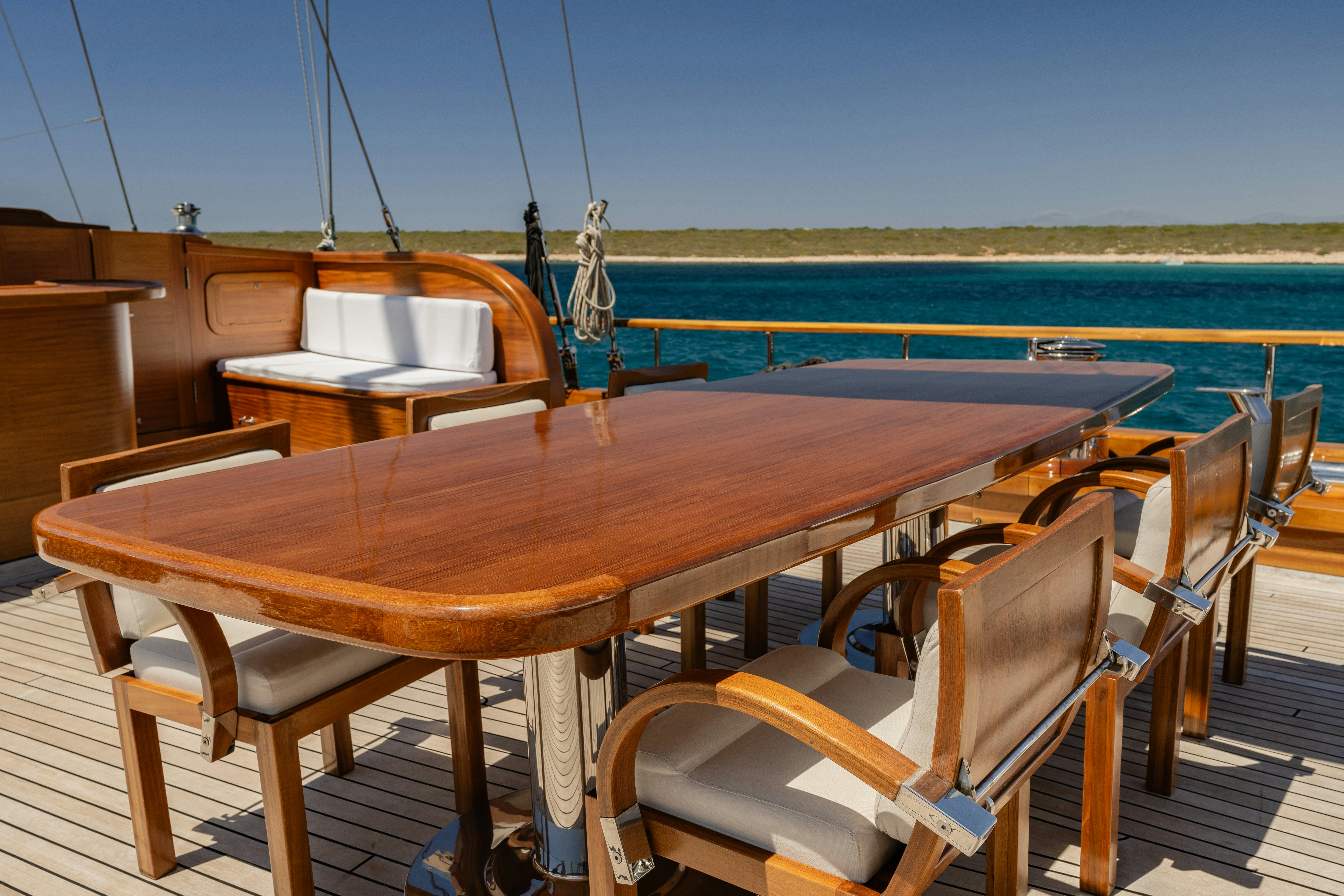a wooden table on a deck overlooking the ocean aboard CAKIRYILDIZ Yacht for Sale