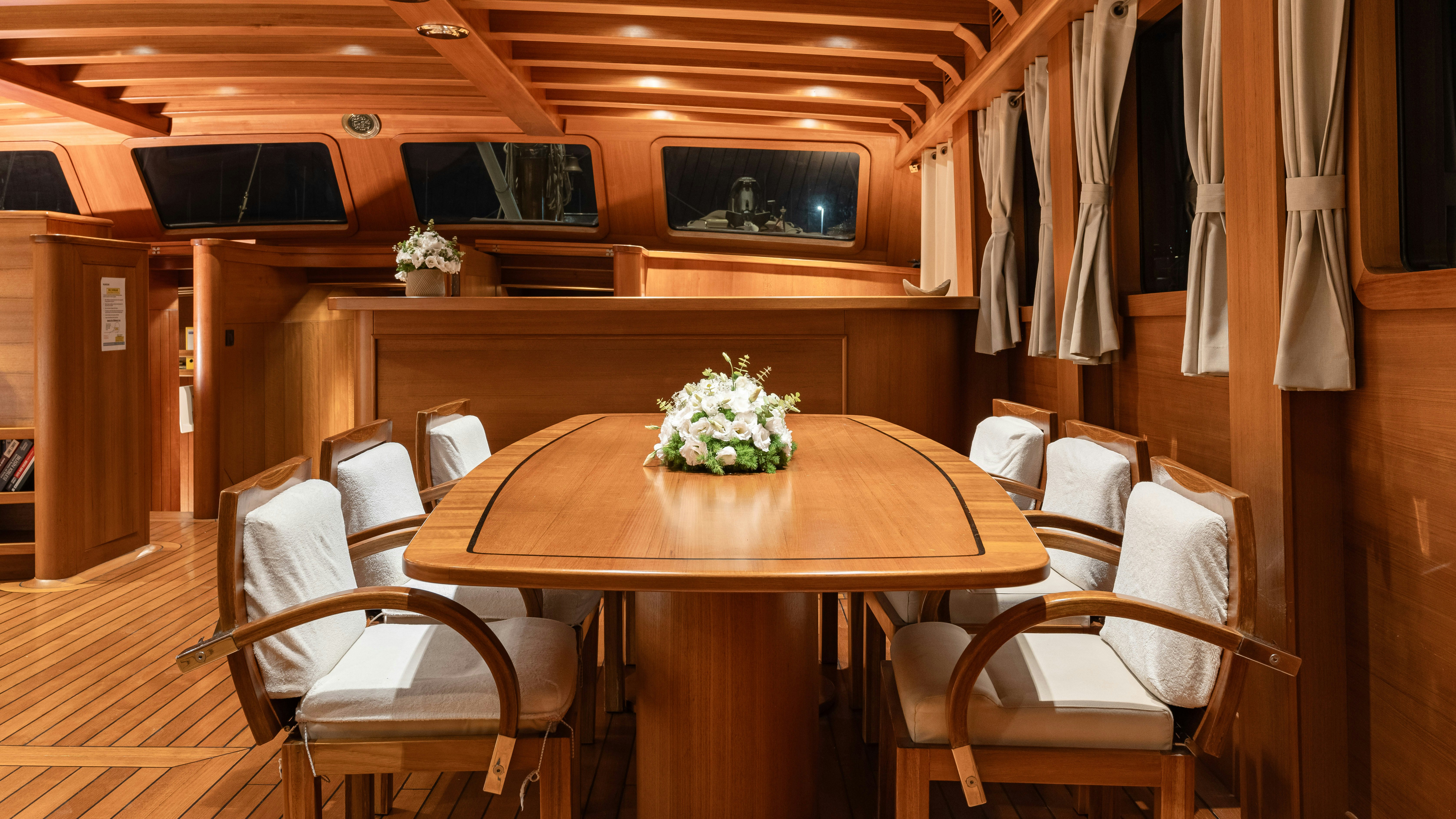 a room with a table and chairs aboard CAKIRYILDIZ Yacht for Sale