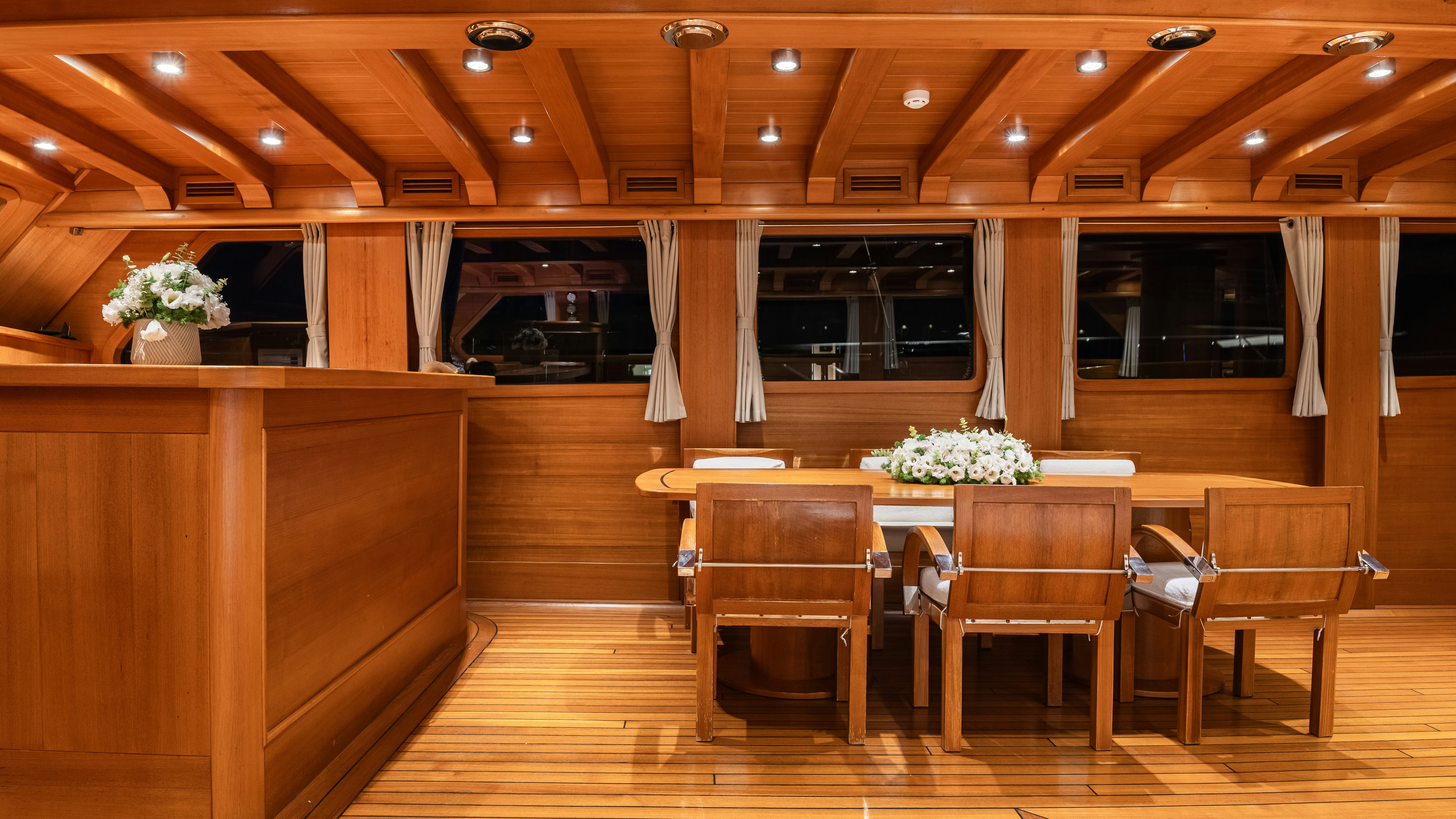 a room with a table and chairs aboard CAKIRYILDIZ Yacht for Sale