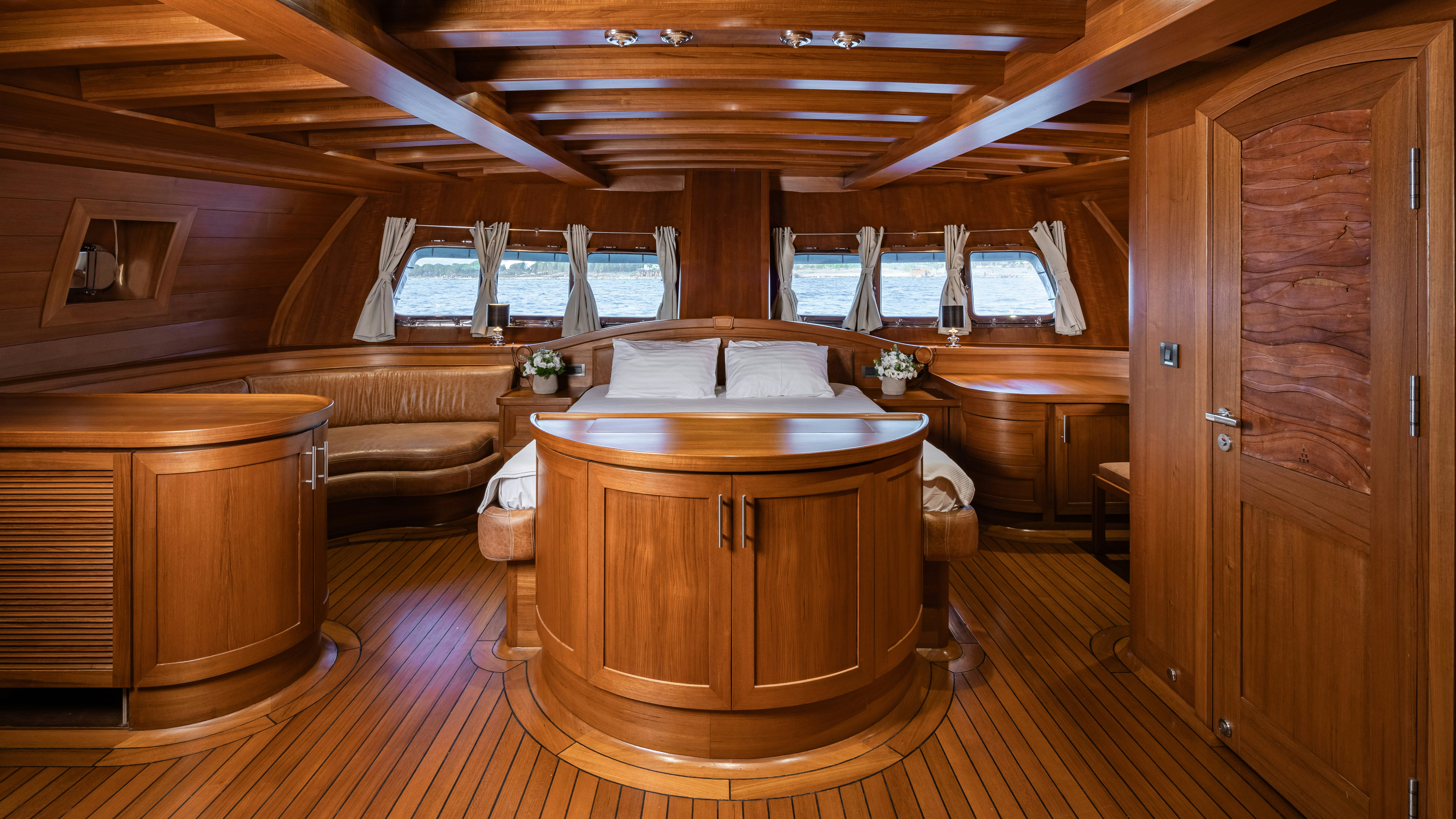 a room with a wood table and chairs aboard CAKIRYILDIZ Yacht for Sale