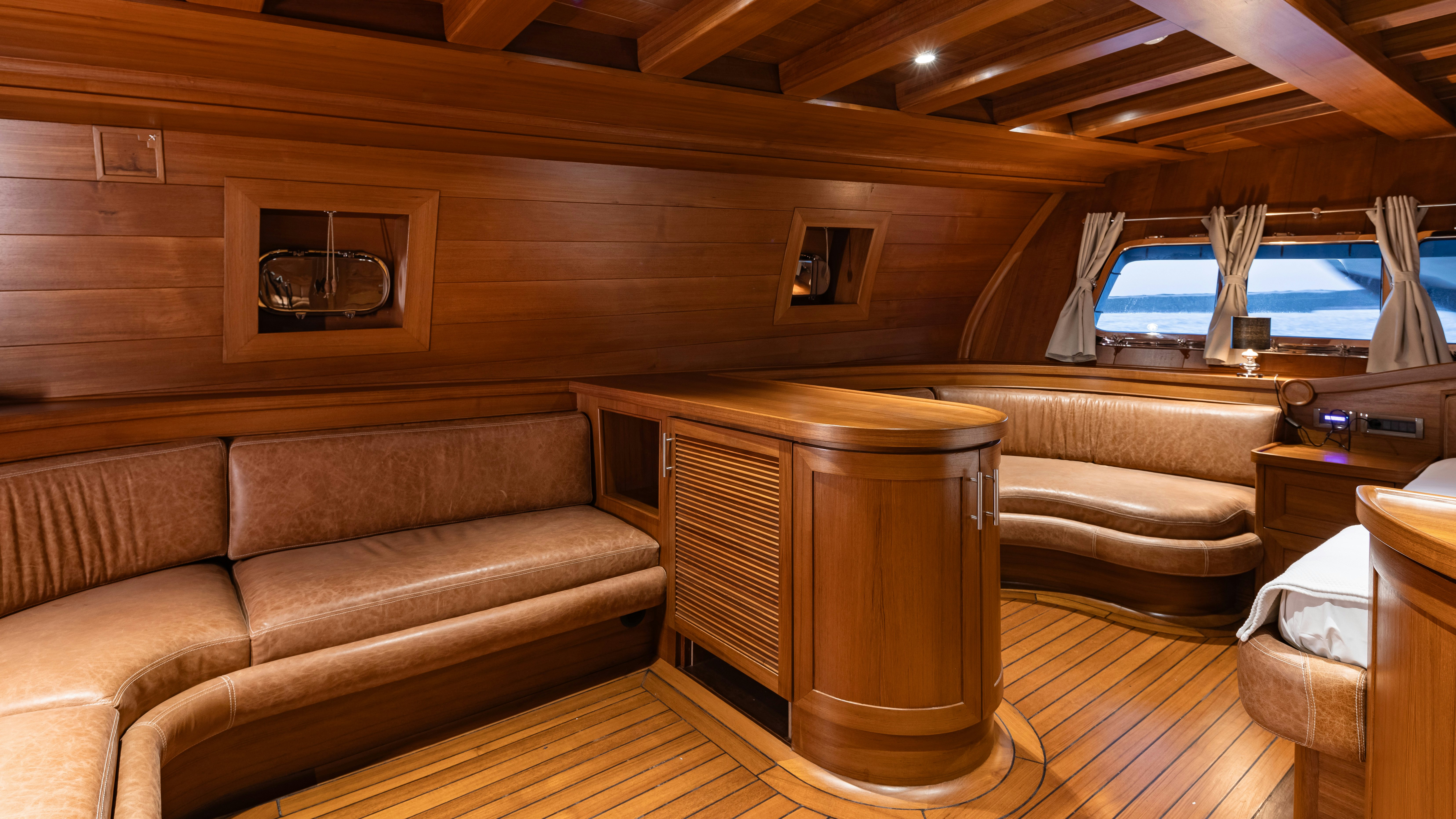 a room with a couch and a table aboard CAKIRYILDIZ Yacht for Sale