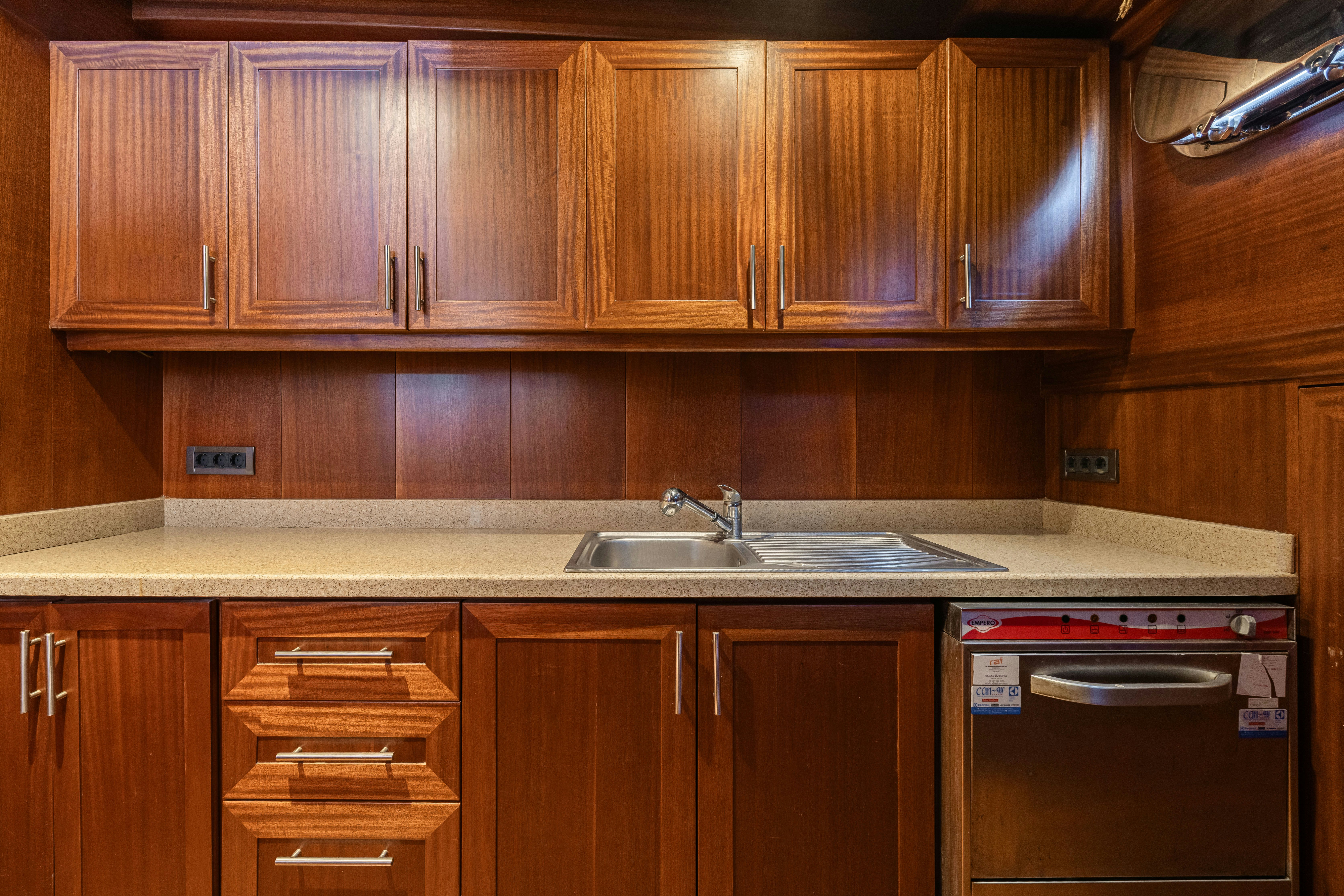 a kitchen with wooden cabinets aboard CAKIRYILDIZ Yacht for Sale