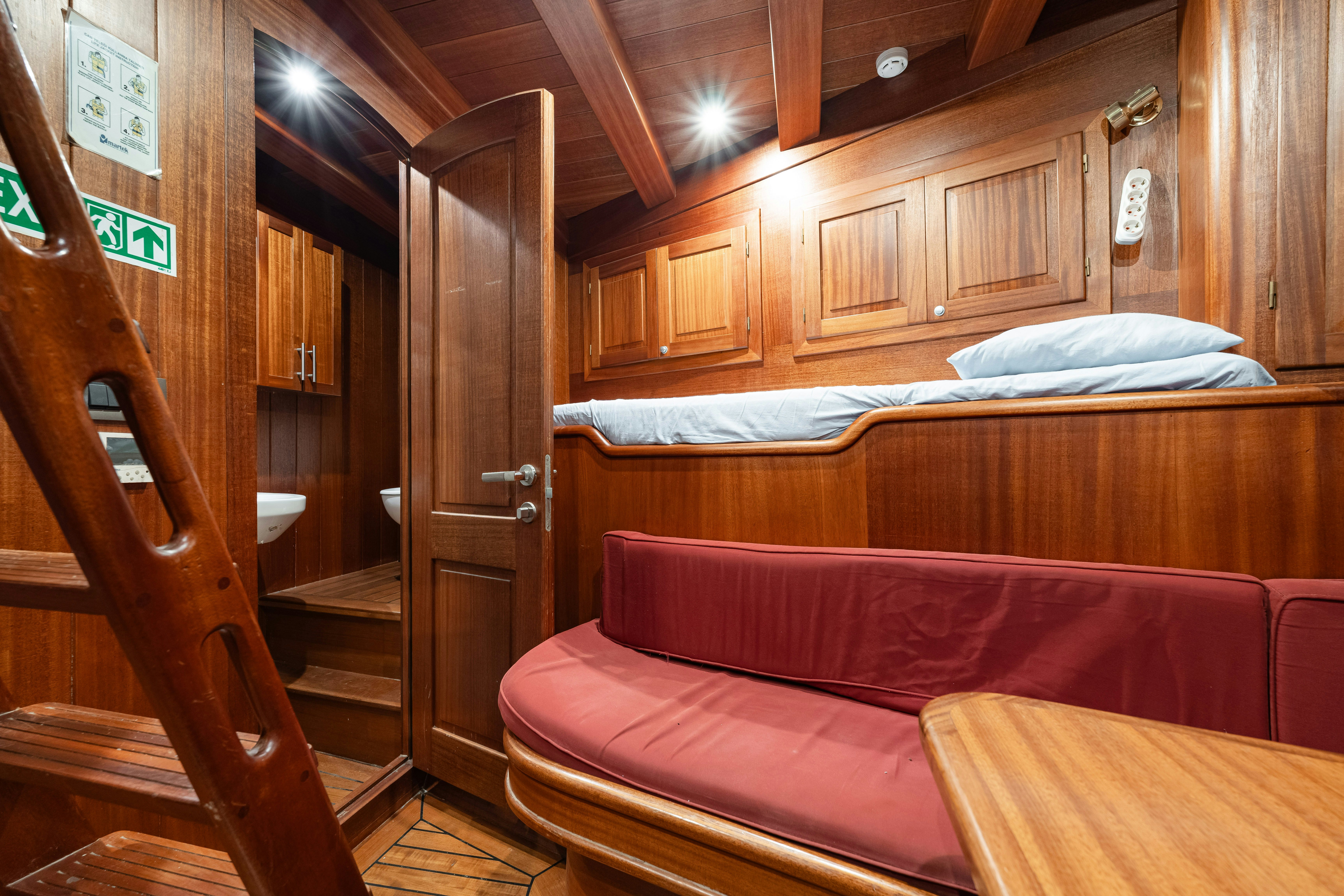 a bed and a chair in a room aboard CAKIRYILDIZ Yacht for Sale