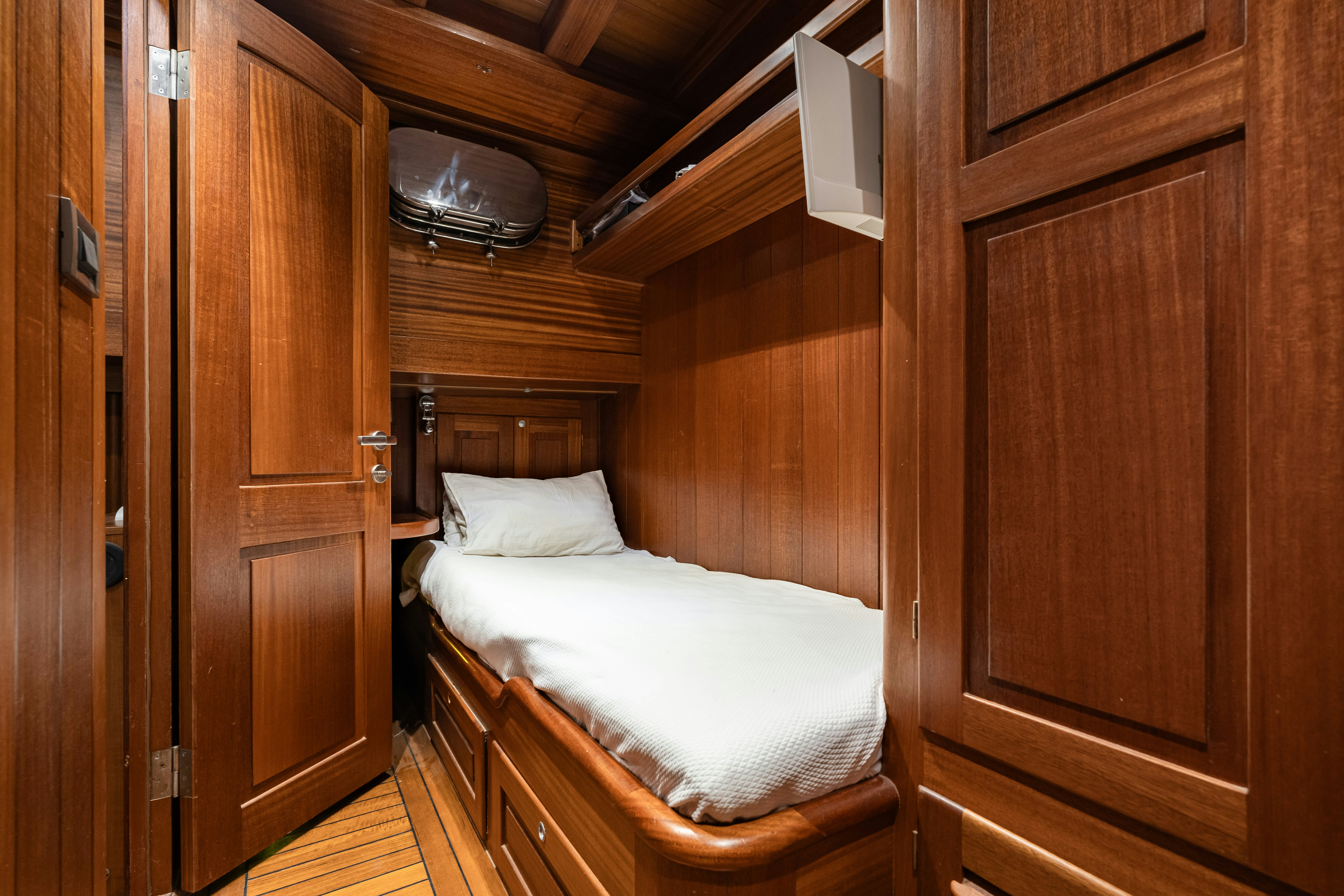 a bedroom with a bed and a closet aboard CAKIRYILDIZ Yacht for Sale