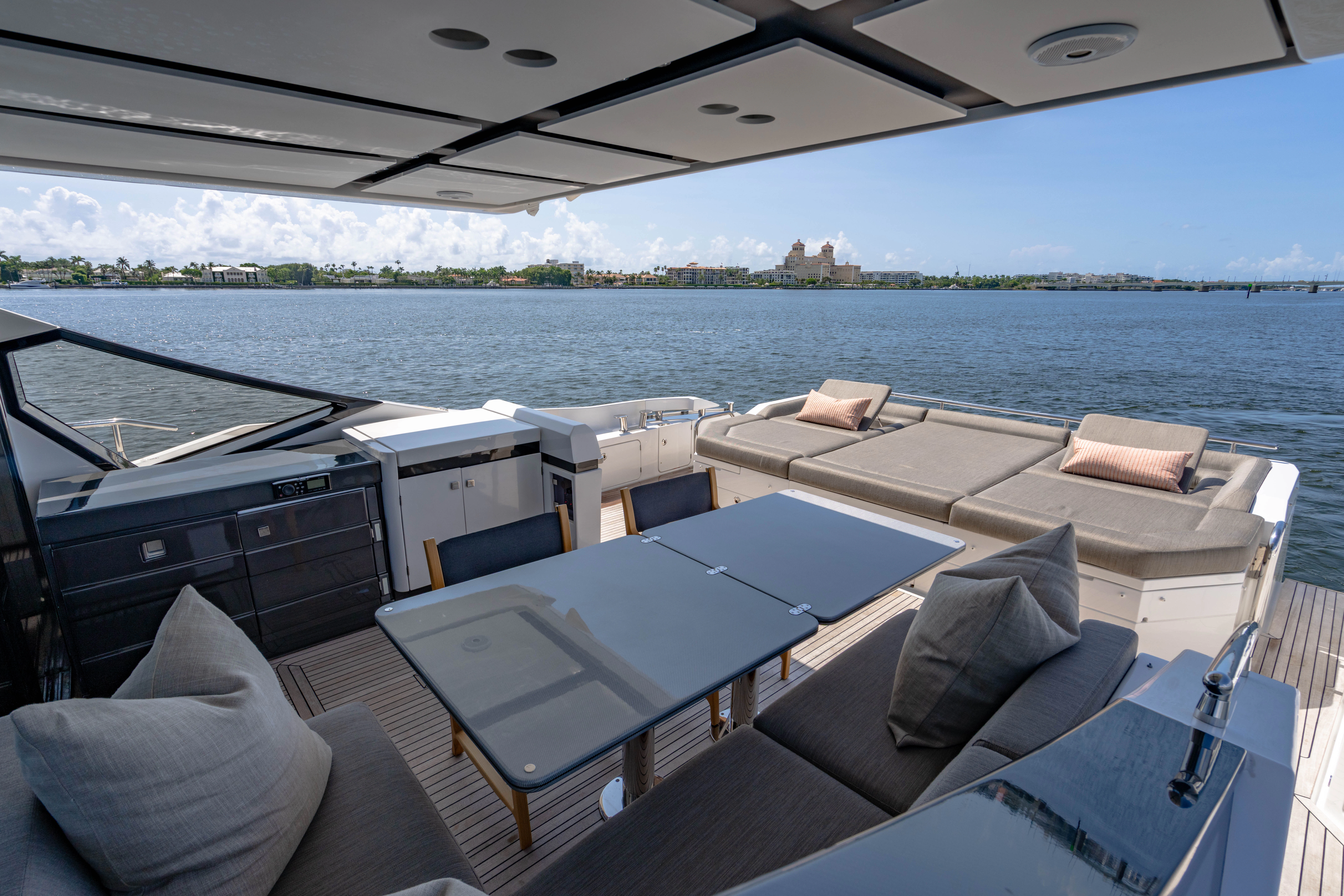 a boat with a view of the water and a city in the background aboard ESCAPIST Yacht for Sale