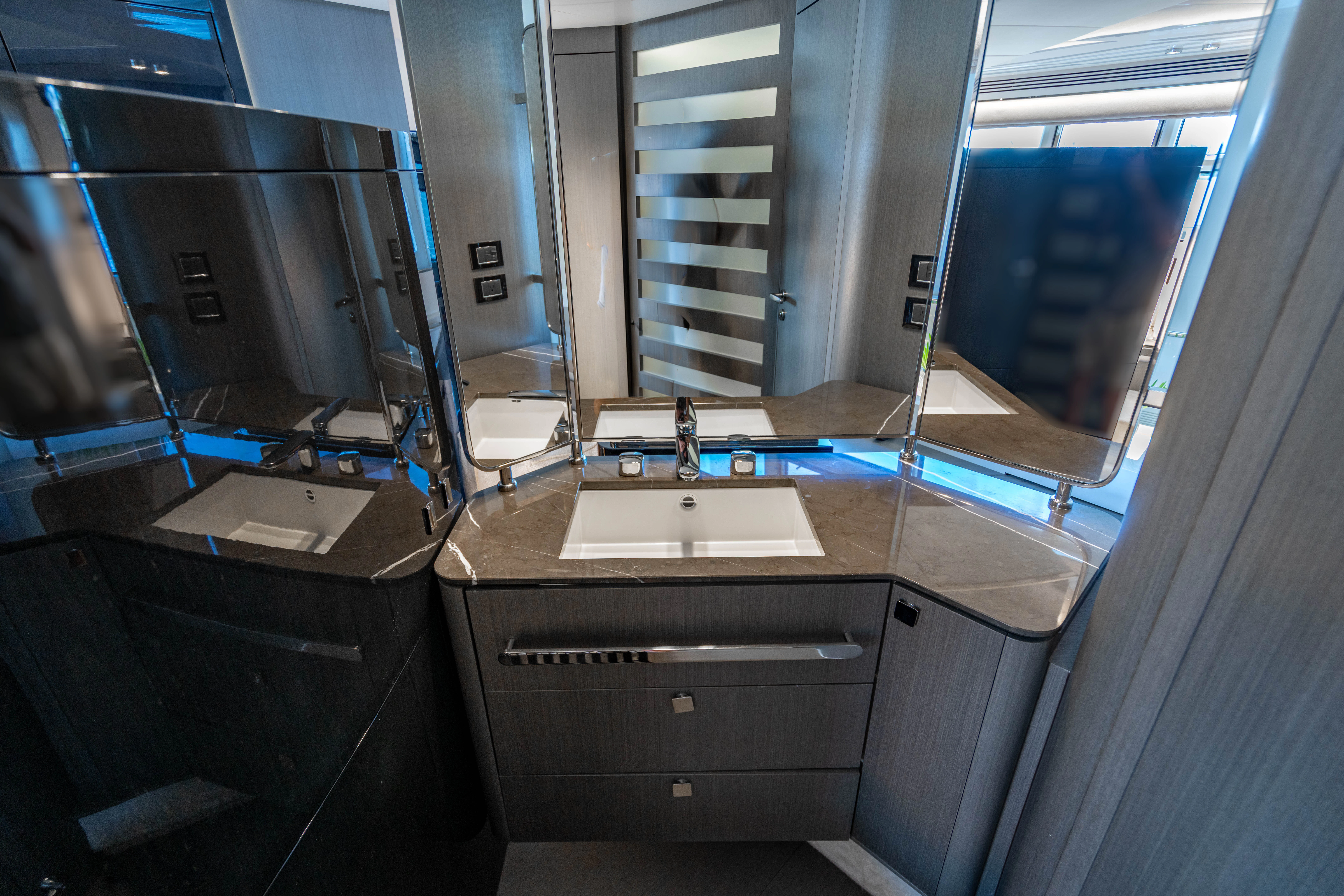 a bathroom with a sink and a mirror aboard ESCAPIST Yacht for Sale