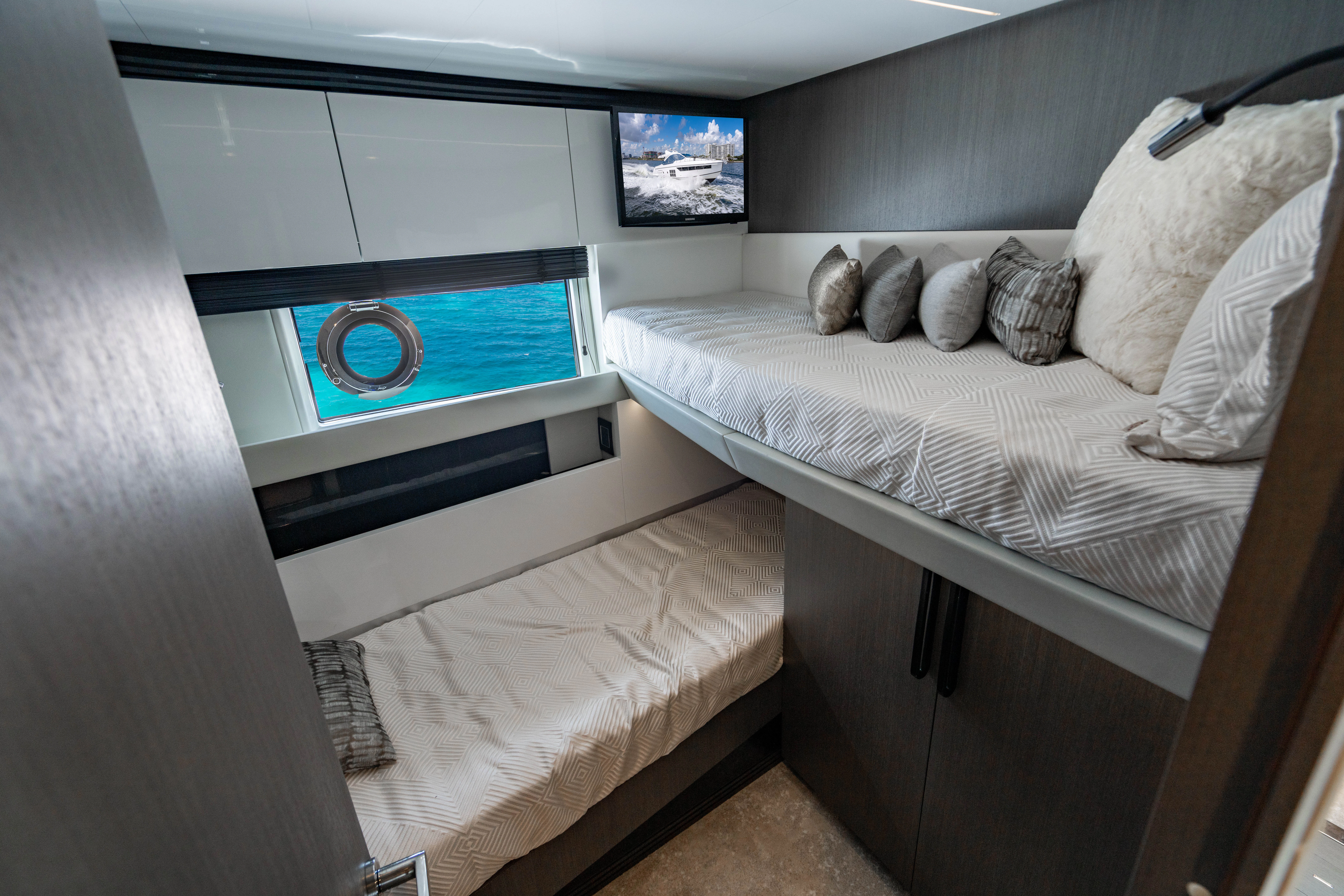 a bed with a television on the wall aboard ESCAPIST Yacht for Sale