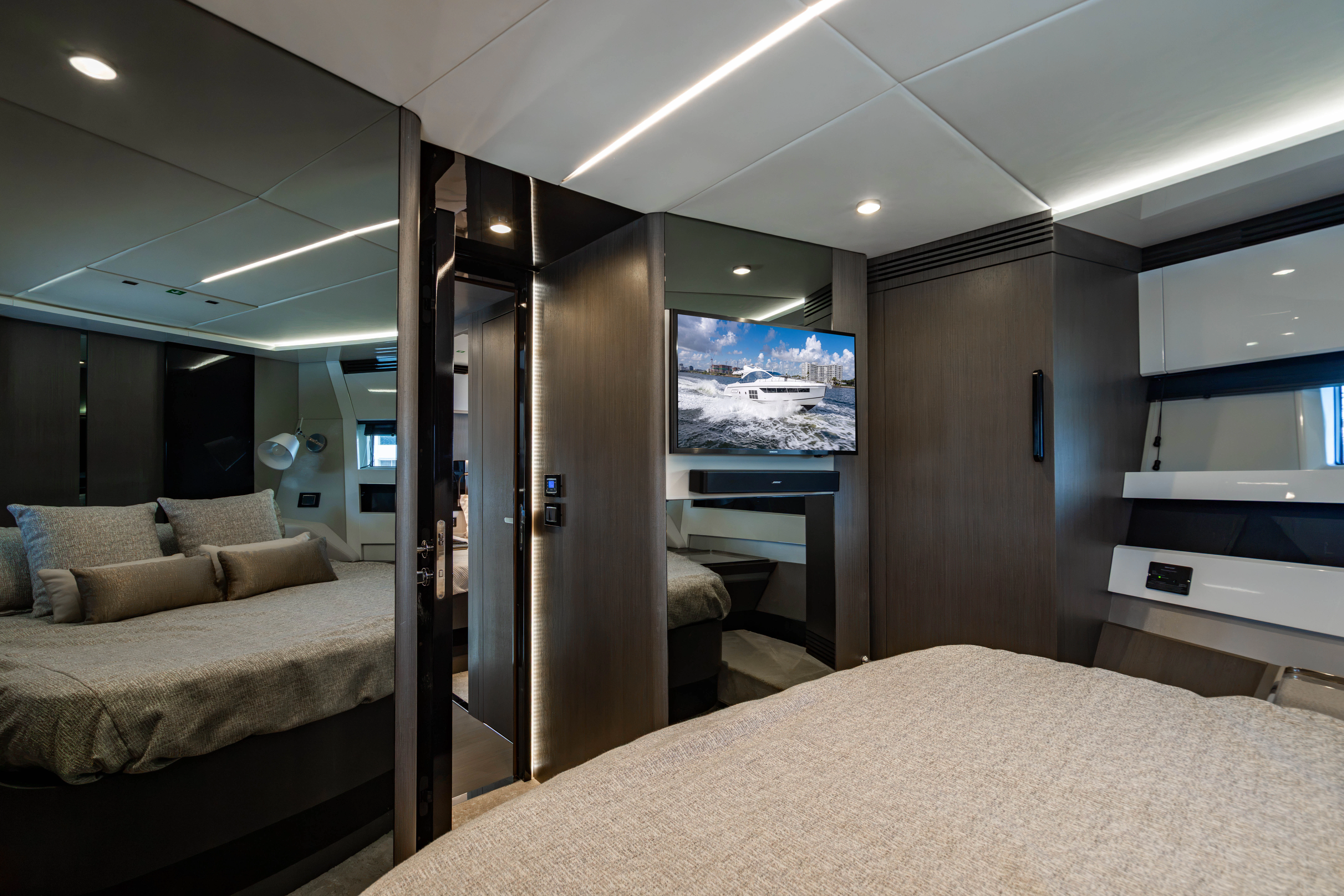 a bedroom with a bed and a mirror aboard ESCAPIST Yacht for Sale