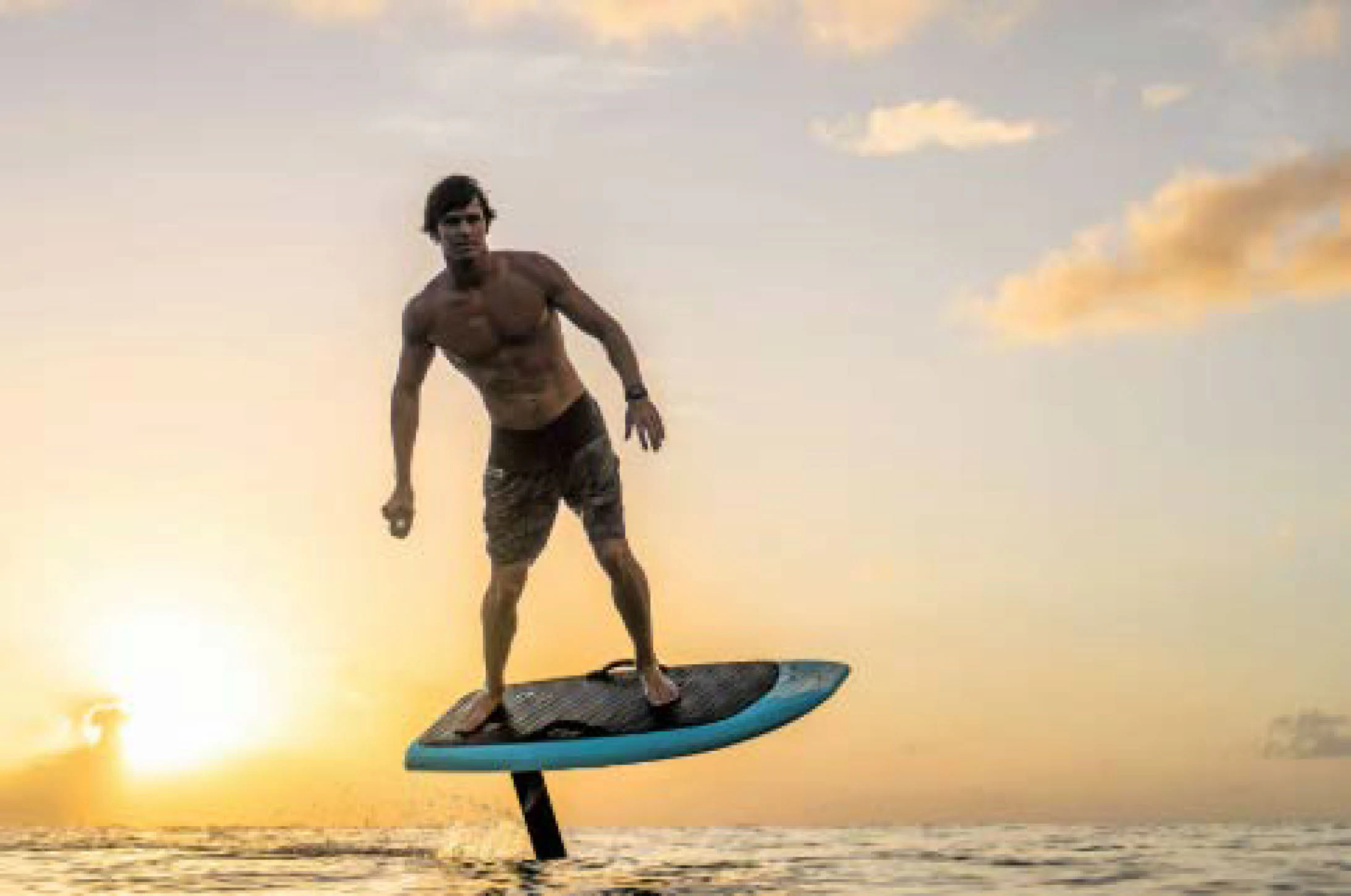 a man on a surfboard aboard AWANDRA Yacht for Charter