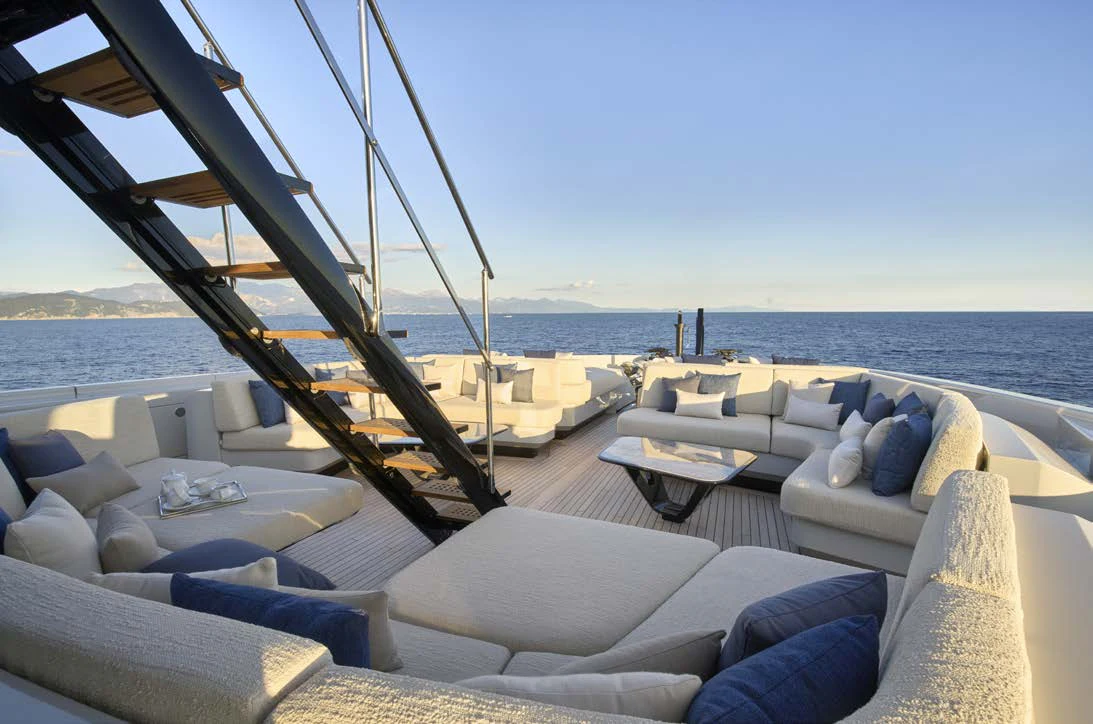 a large lounge area with a large body of water in the background aboard AWANDRA Yacht for Charter